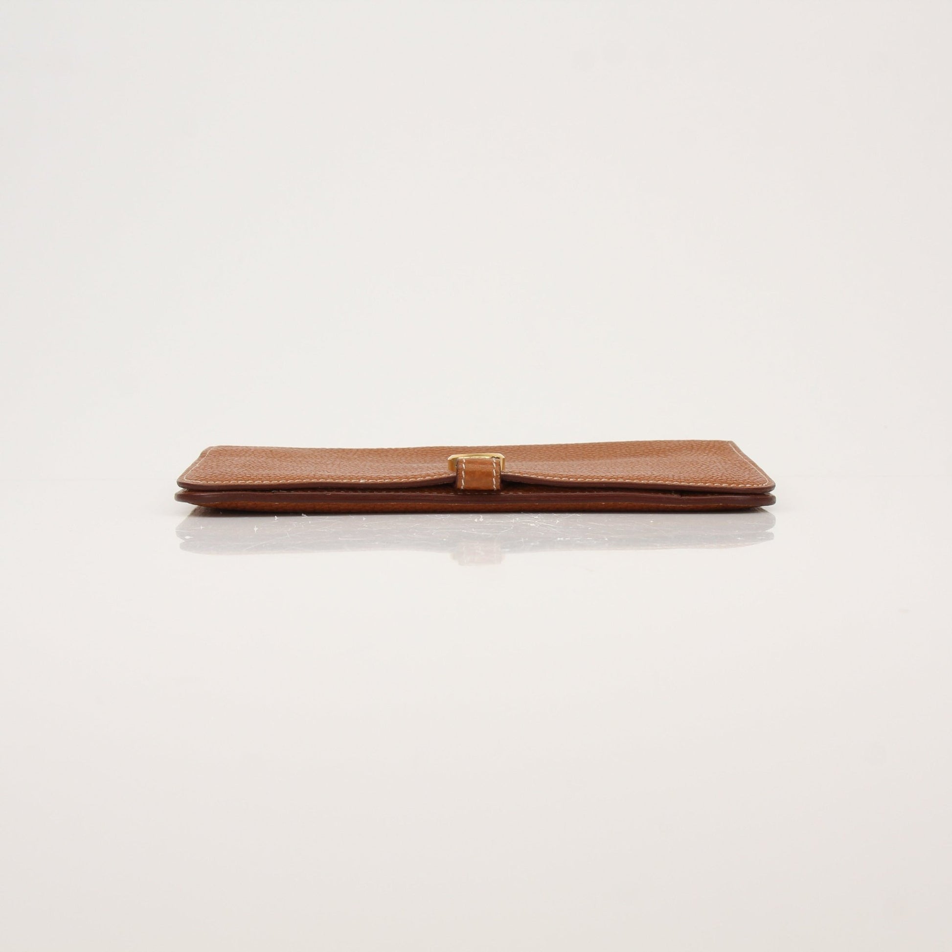 Hermès Brown Dogon Wallet by Gold & Beyond showing textured leather exterior with gold hardware details.