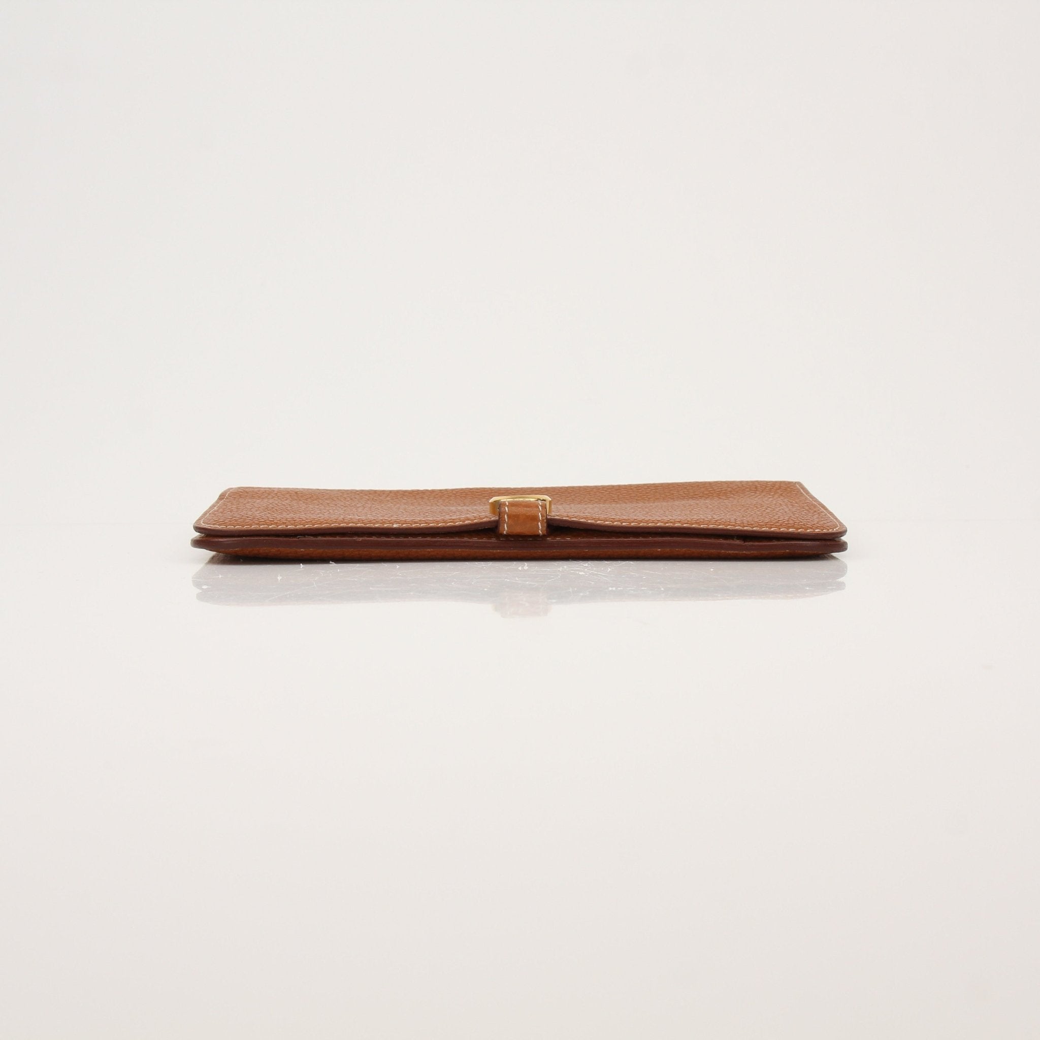 Hermès Brown Dogon Wallet by Gold & Beyond showing textured leather exterior with gold hardware details.