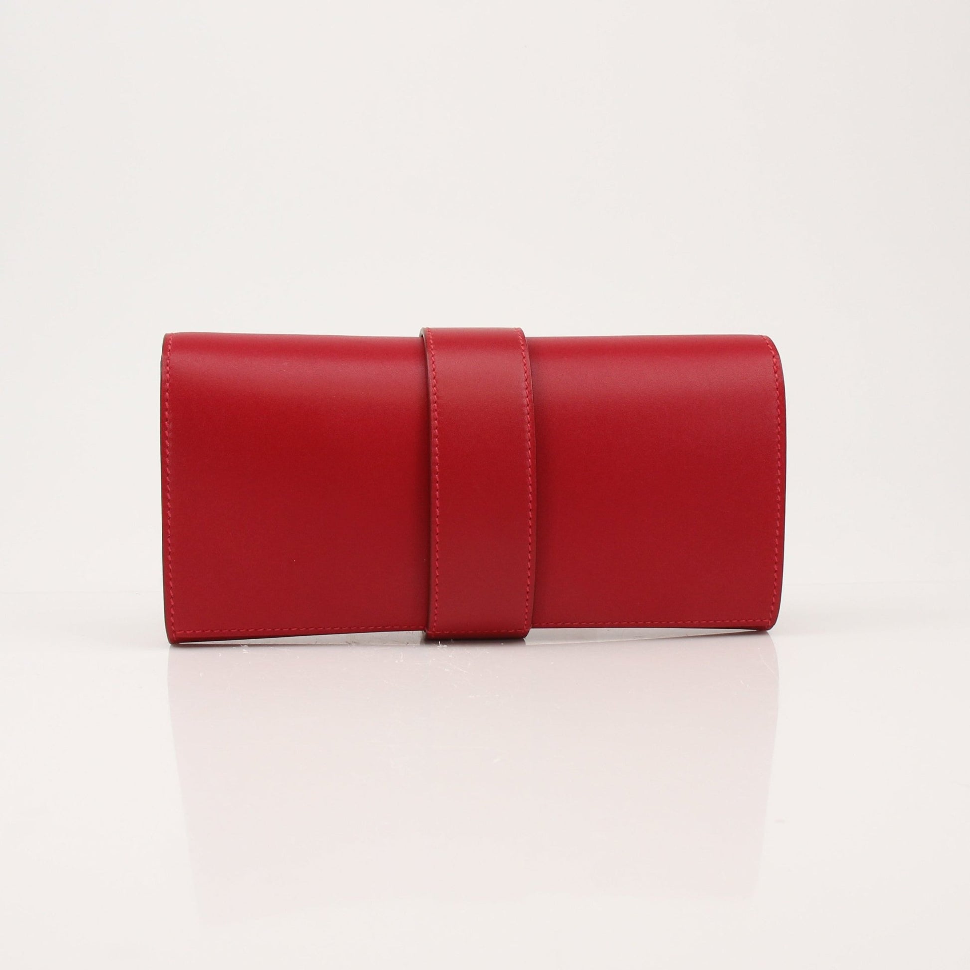 Hermès Médor 23 red leather clutch handbag with gold hardware, featuring a sleek, compact design and signature medor detailing.