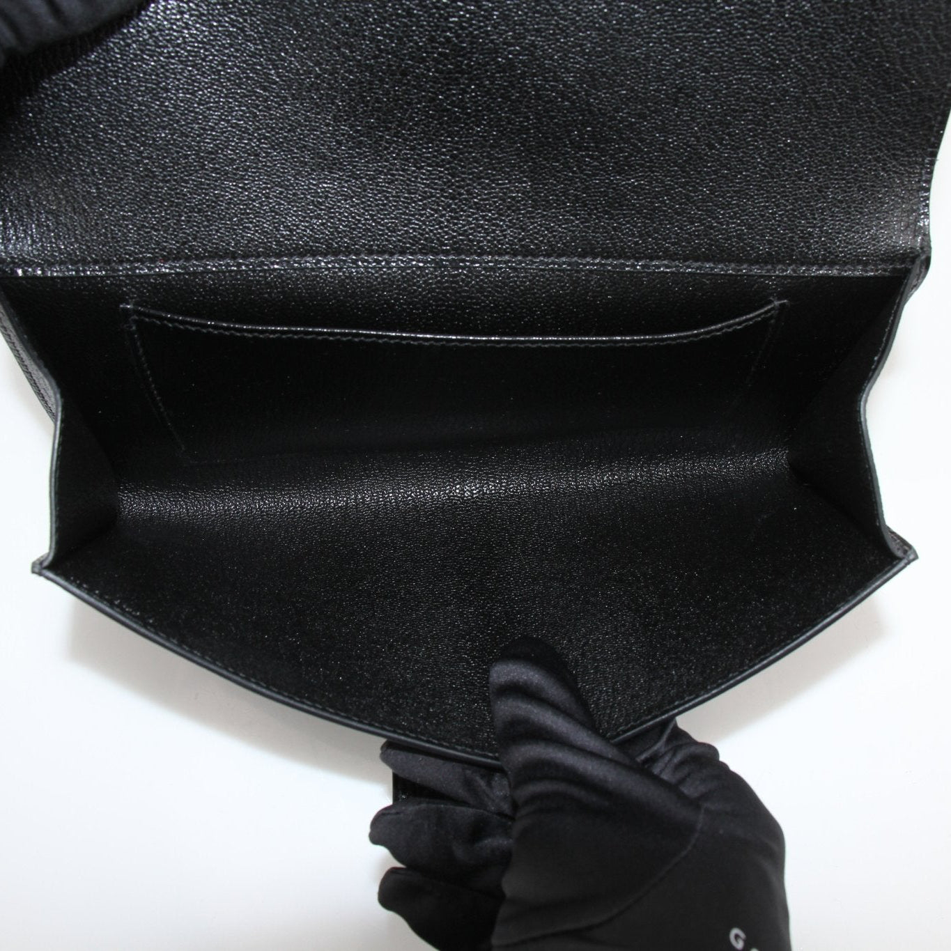 Hermès Collier de Chien black clutch handbag by Gold & Beyond featuring a structured design and signature hardware.