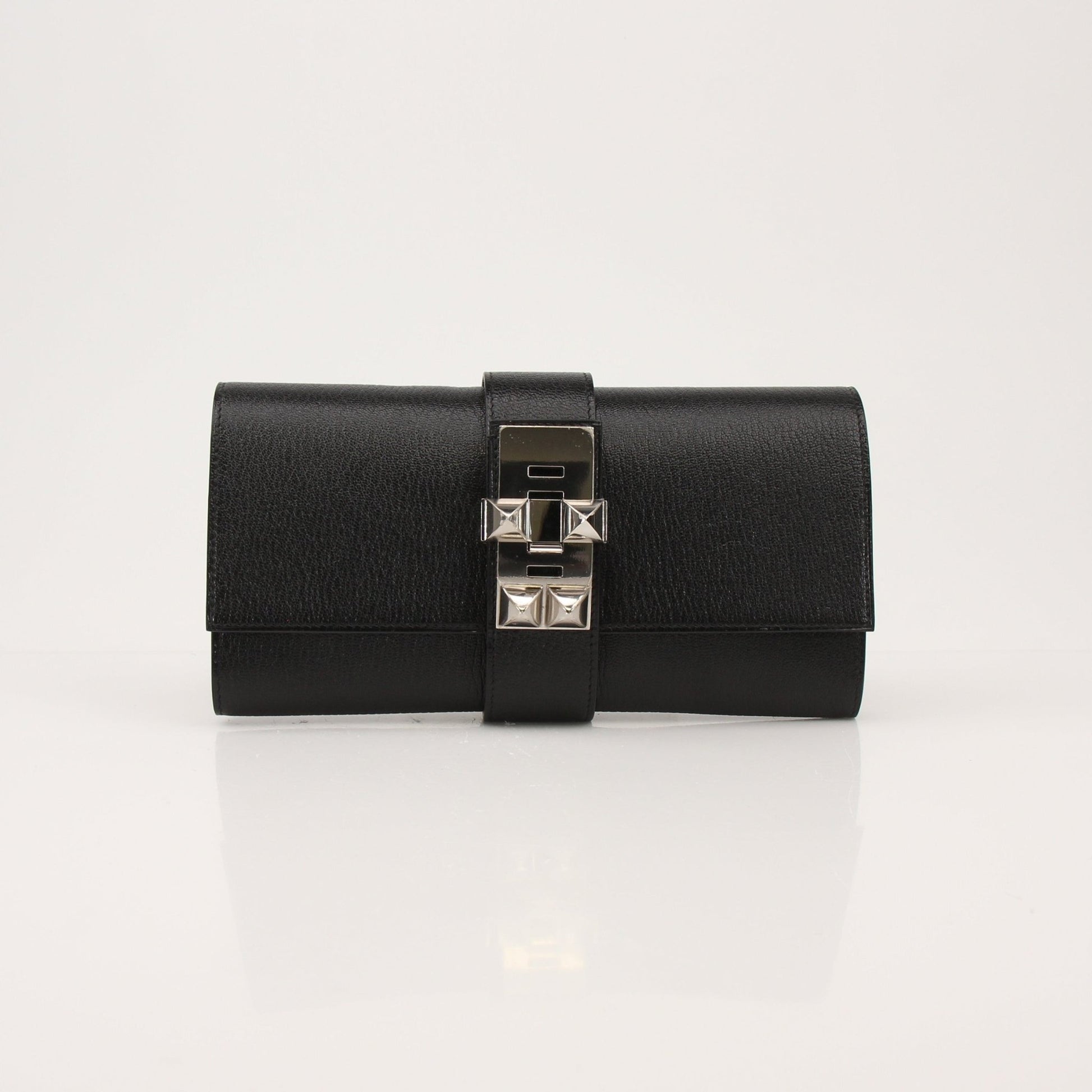 Hermès Collier de Chien black clutch handbag with gold hardware and textured leather, stylish and compact accessory.