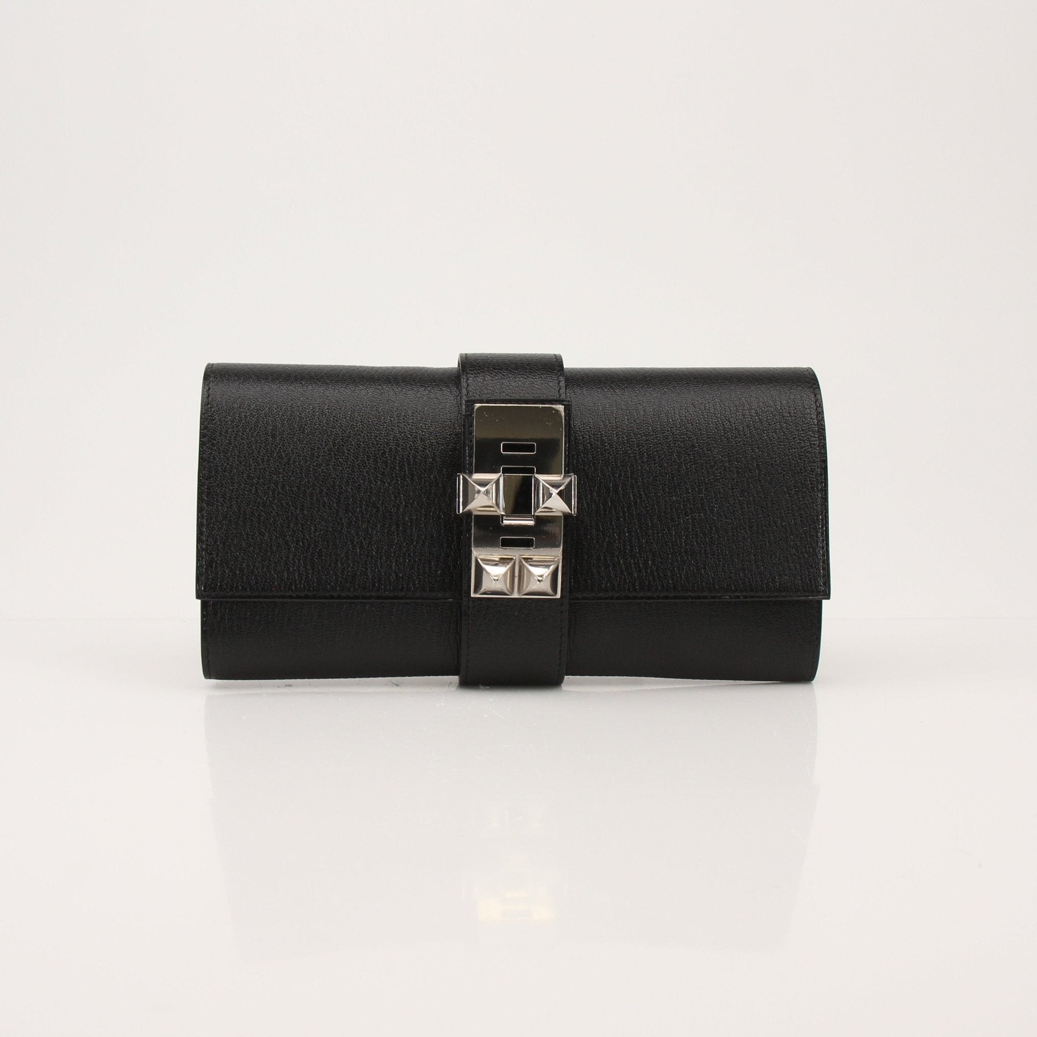 Hermès Collier de Chien black clutch handbag with gold hardware and textured leather, stylish and compact accessory.