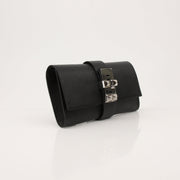 Hermès Collier de Chien black clutch handbag with gold hardware, showcasing a luxurious, structured design and signature details.