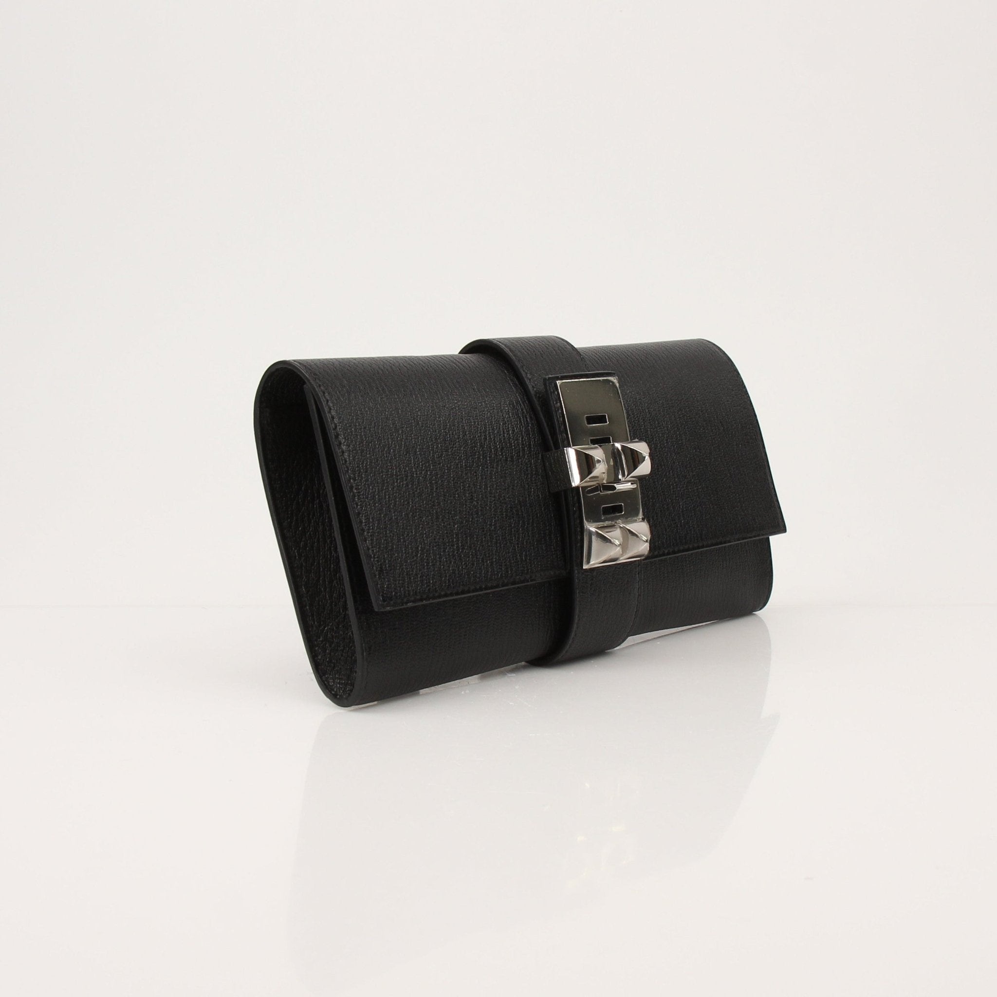 Hermès Collier de Chien black clutch handbag with gold hardware, showcasing a luxurious, structured design and signature details.