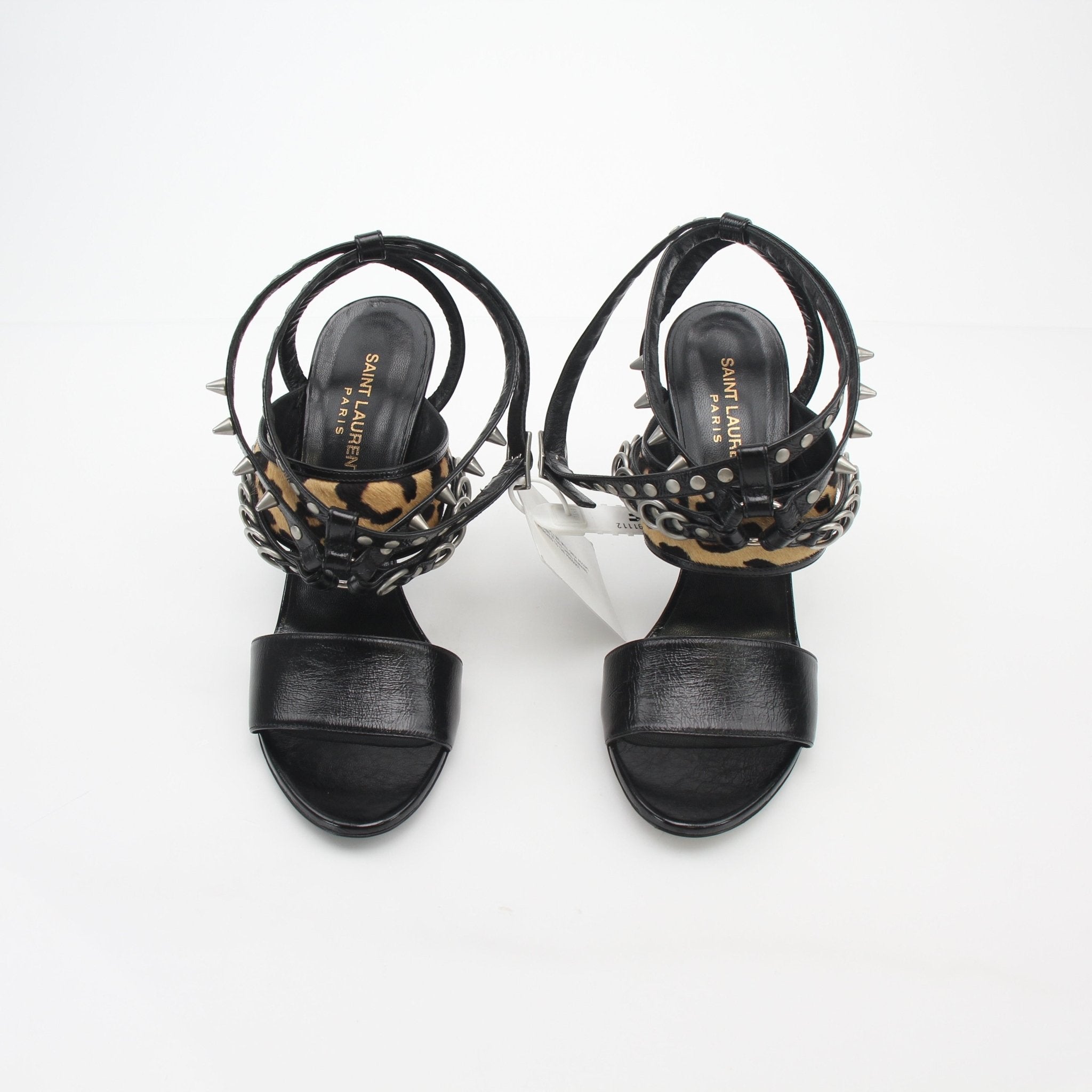 Black studded leopard-print high-heel sandals by Saint Laurent, featuring sleek design and gold accents.