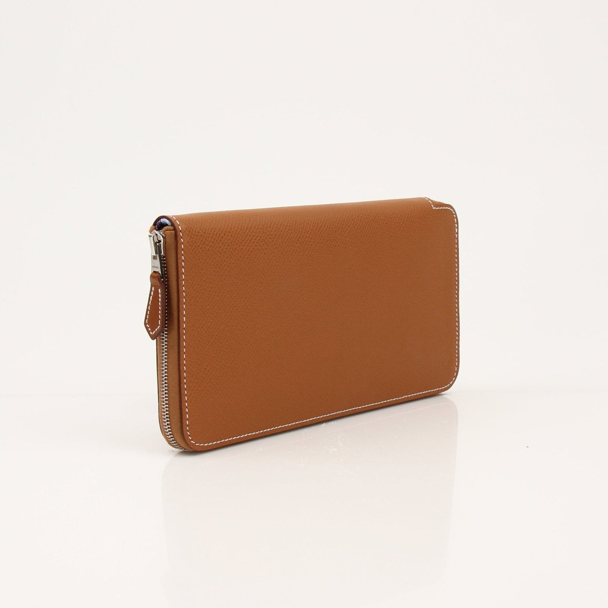 Hermès Brown Veau Epsom Silk In Wallet with gold-tone hardware, compact design, and textured leather finish.