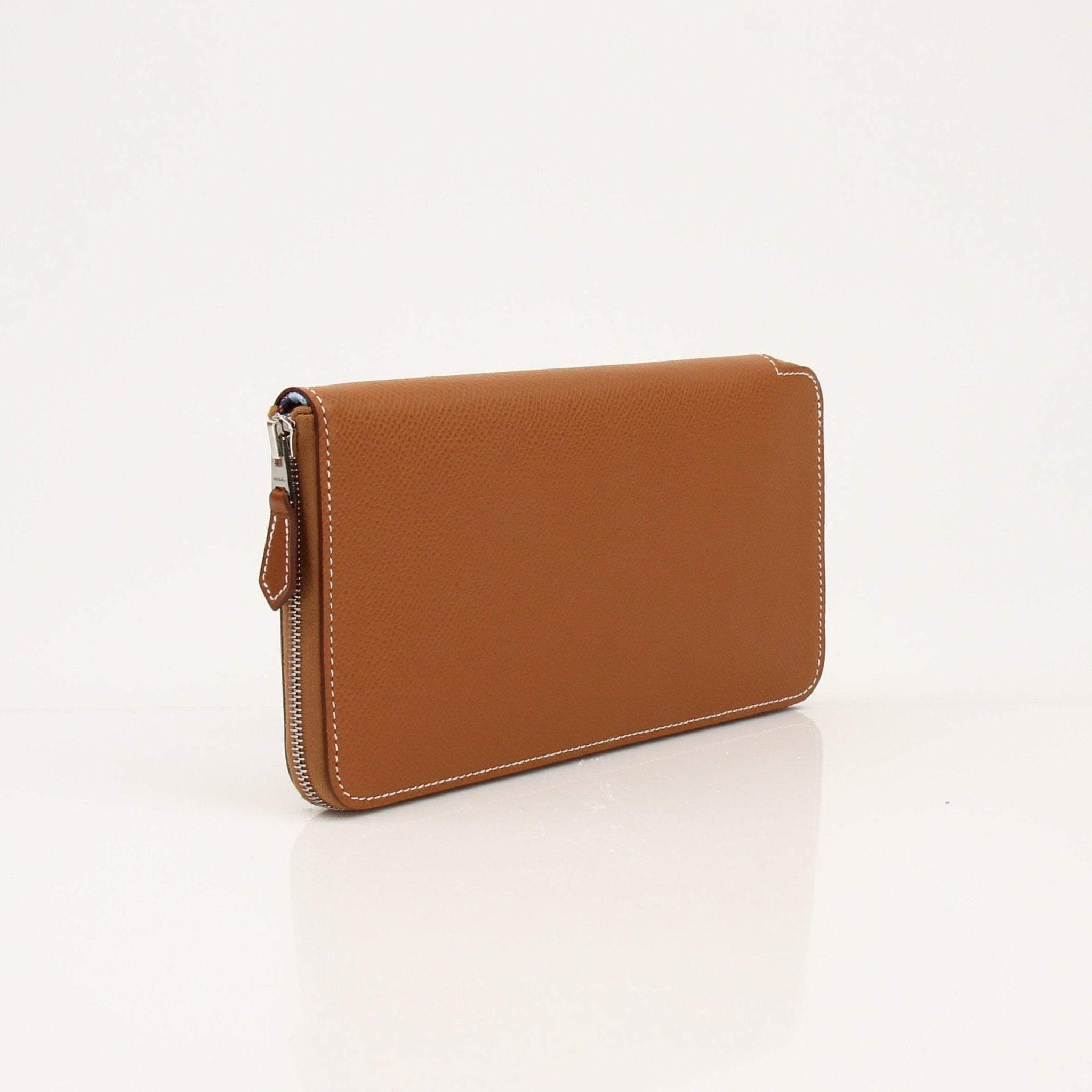 Hermès Brown Veau Epsom Silk In Wallet with gold-tone hardware, compact design, and textured leather finish.