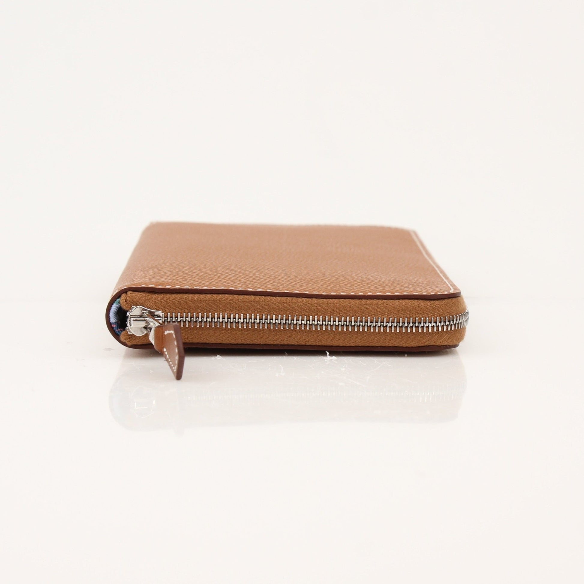 Brown Hermès Veau Epsom Silk In Wallet with gold-tone hardware, featuring multiple card slots and a sleek design.