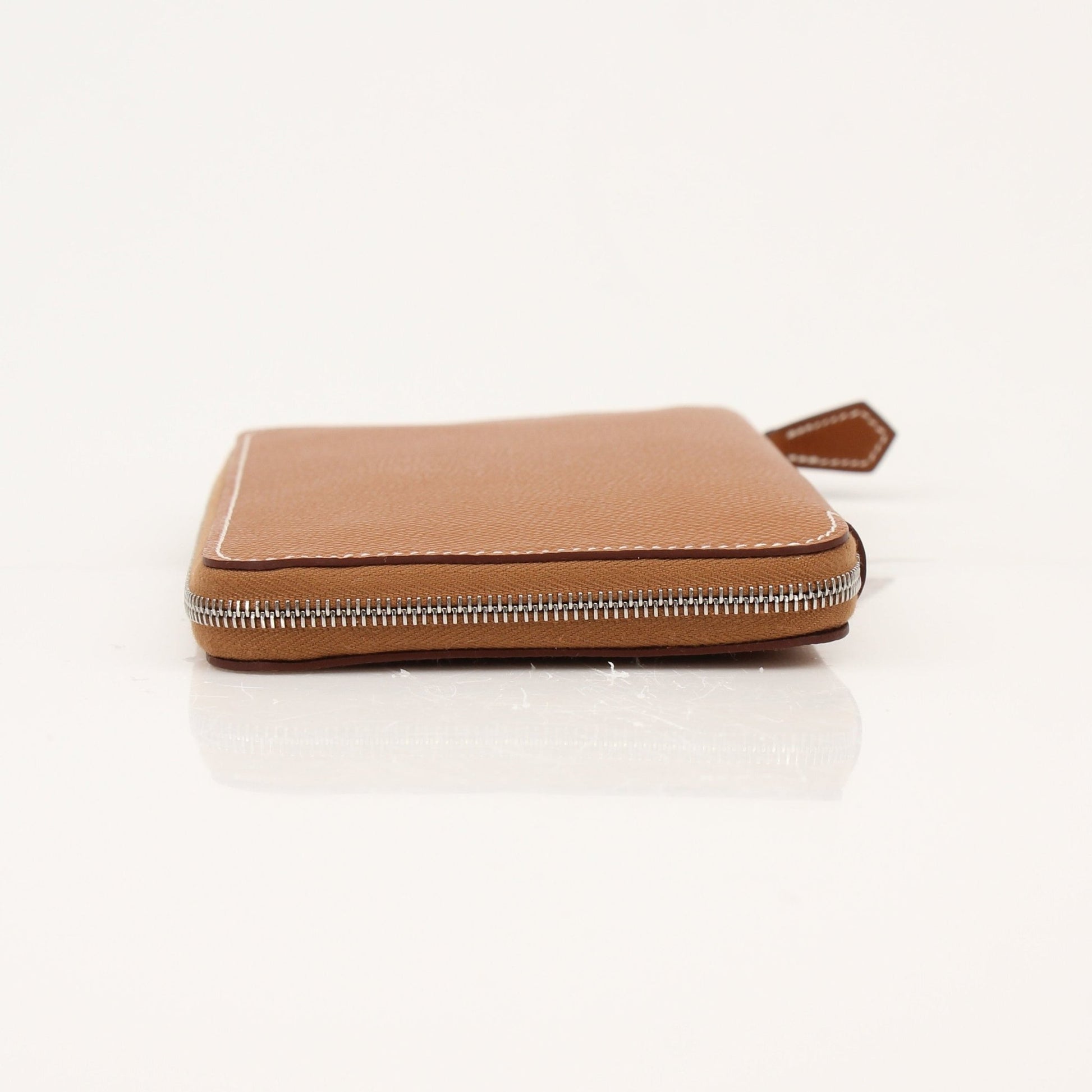 Hermès brown Veau Epsom silk wallet featuring a sleek design and gold-tone accents, crafted by Gold & Beyond.