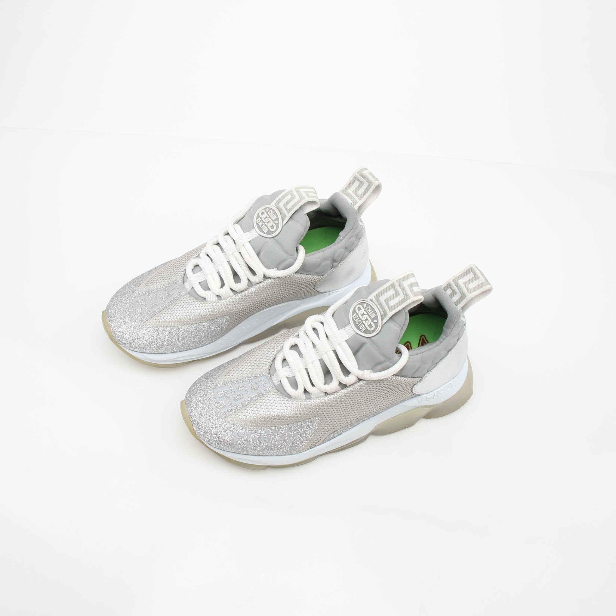 Versace Silver Chain Reaction low-top sneakers by Gold & Beyond, featuring metallic silver design and stylish athletic shoes.