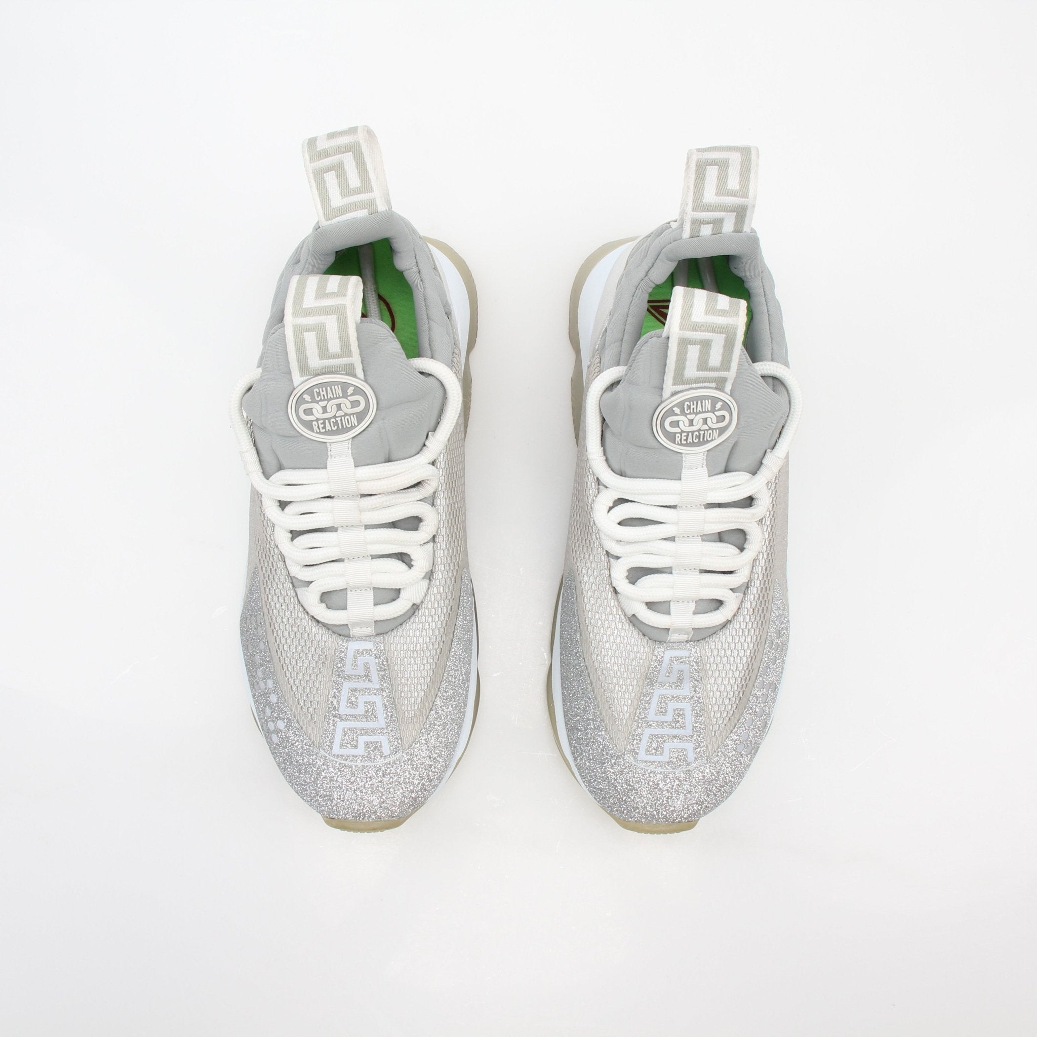 Versace Silver Chain Reaction low-top sneakers by Gold & Beyond, featuring metallic silver design and casual shoe style.