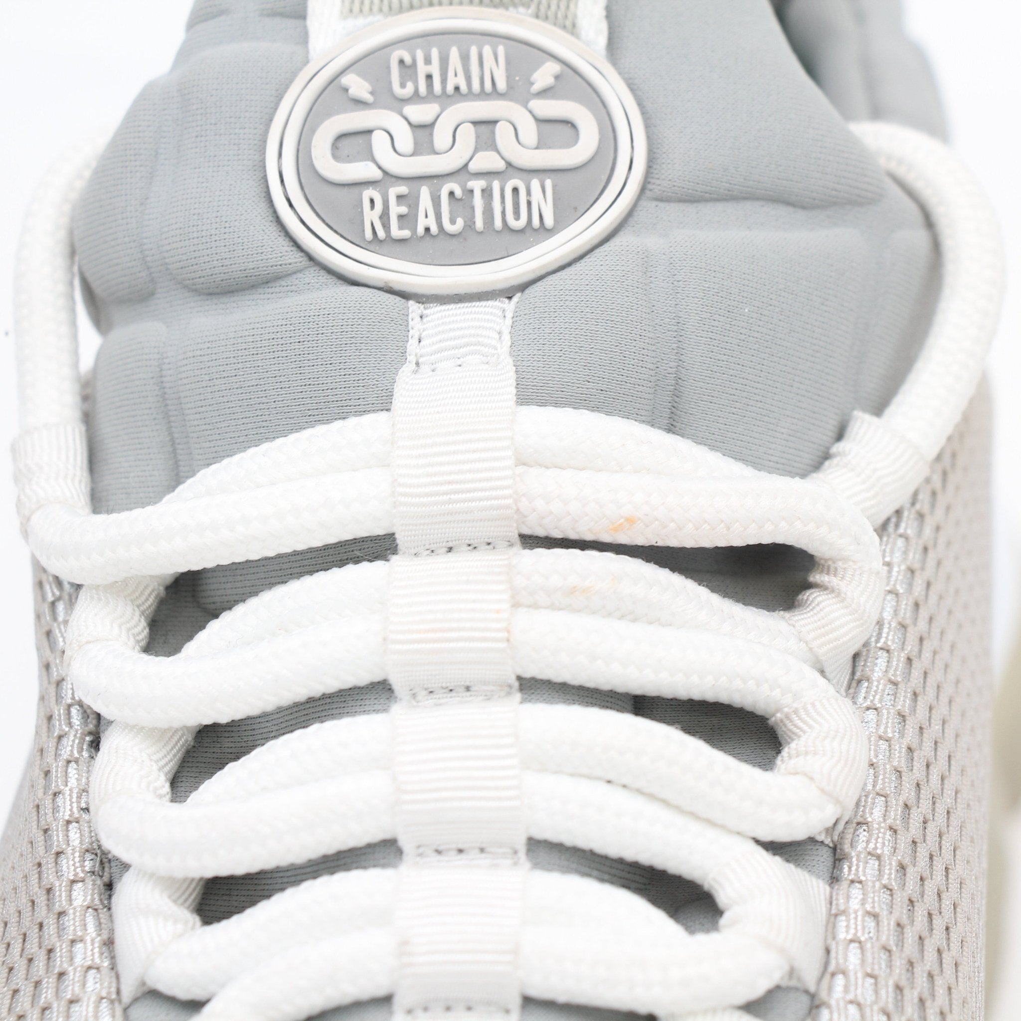 Versace Silver Chain Reaction low-top sneakers with metallic finish and stylish design, displayed on a plain background.