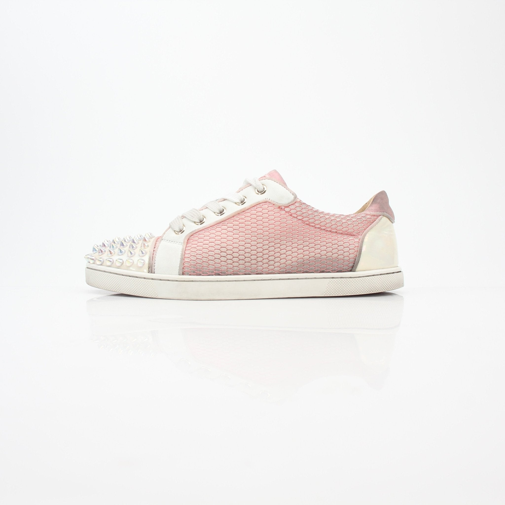 Pink Christian Louboutin Gondolita Spikes low-top sneakers with studded detailing, styled with laces and a sleek shoe design.