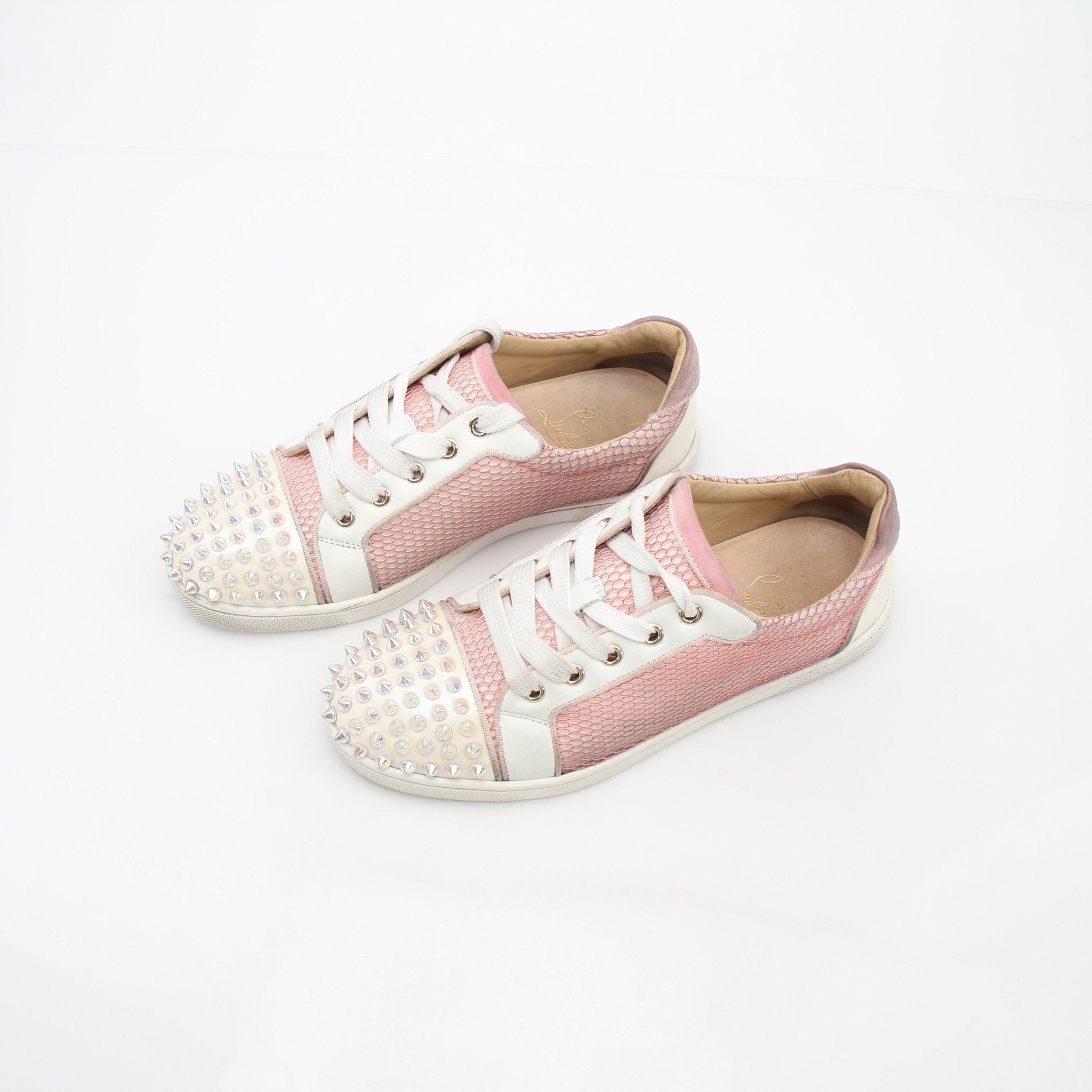 Pink Christian Louboutin Gondolita Spikes low-top sneakers with studded details, displayed on a white background.