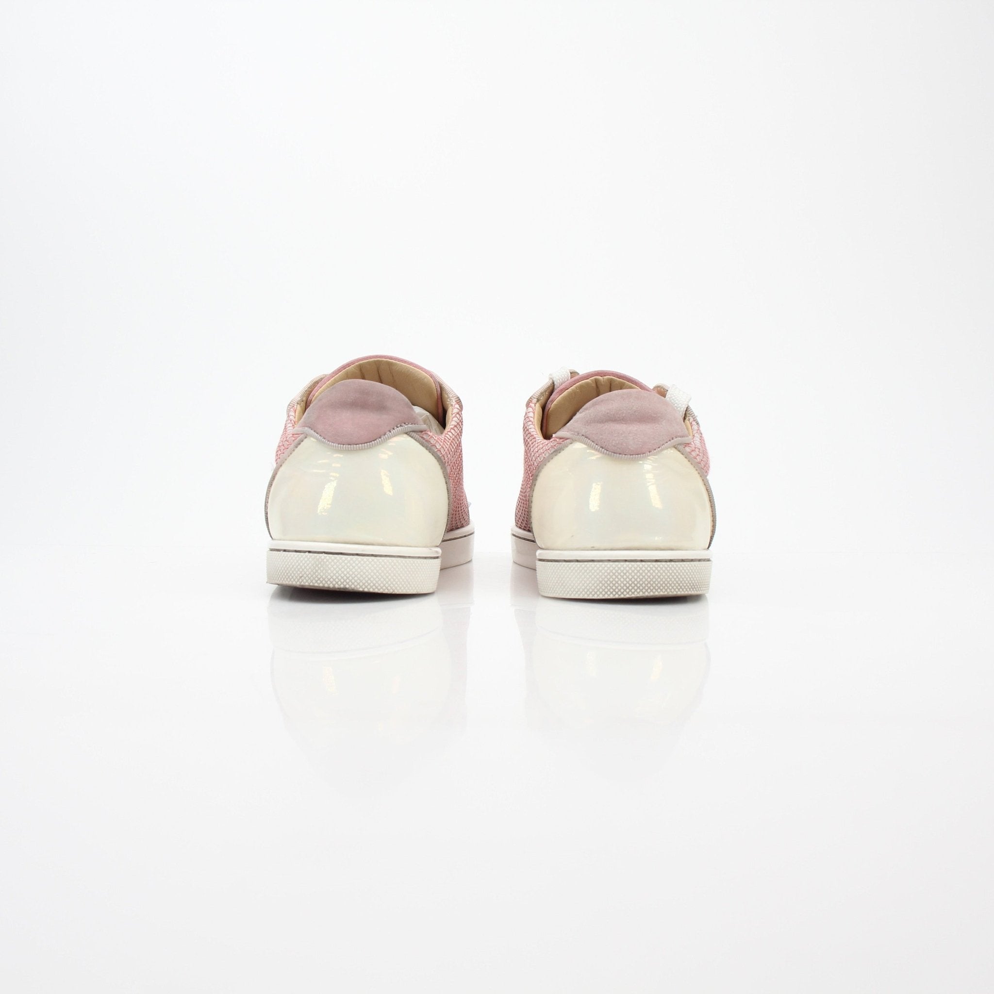 Christian Louboutin Pink Gondolita Spikes low-top sneakers with spikes and laces, displayed on a plain background.