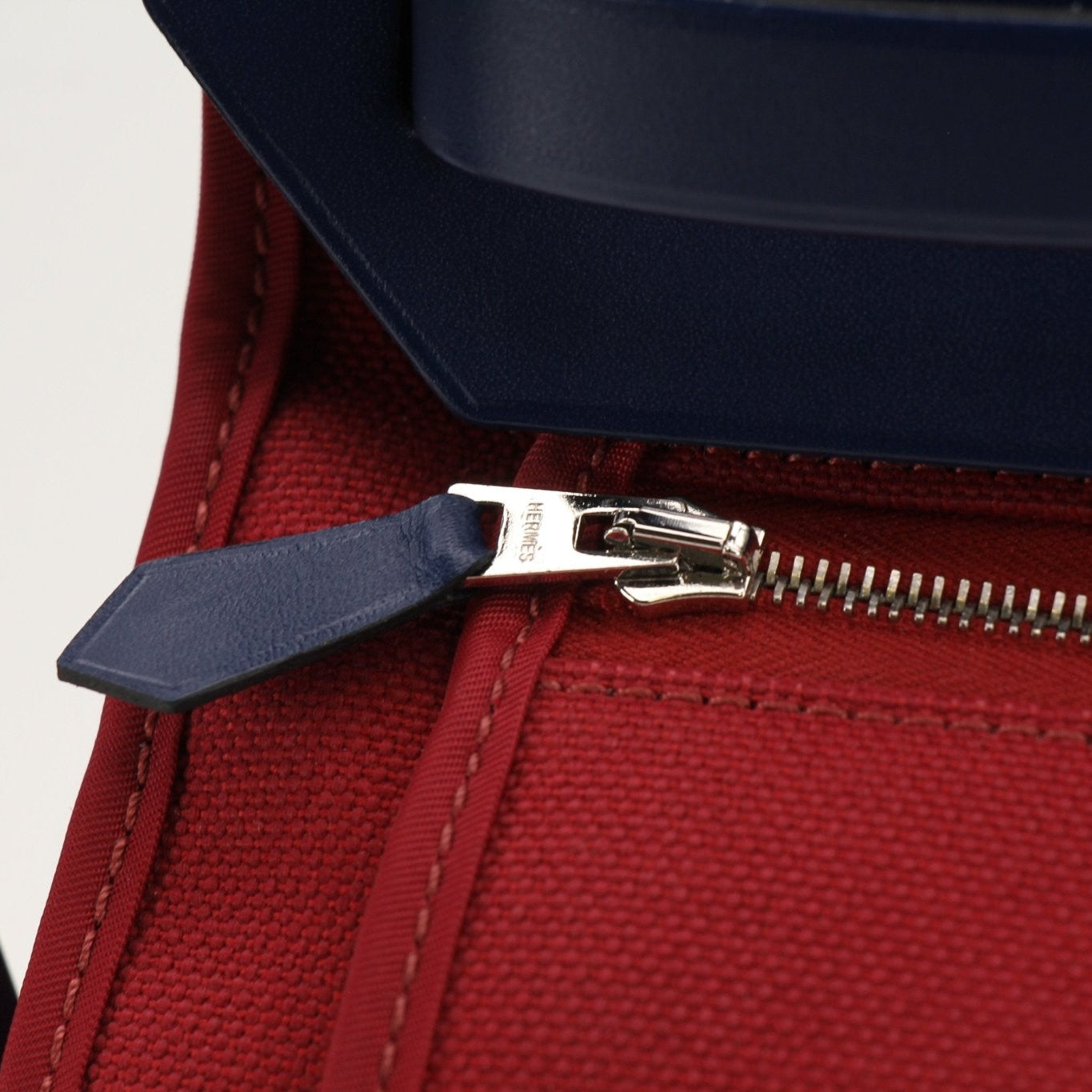 Hermès Herbag handbag by Gold & Beyond, showing tan canvas and leather straps with metal hardware and clasp detail.