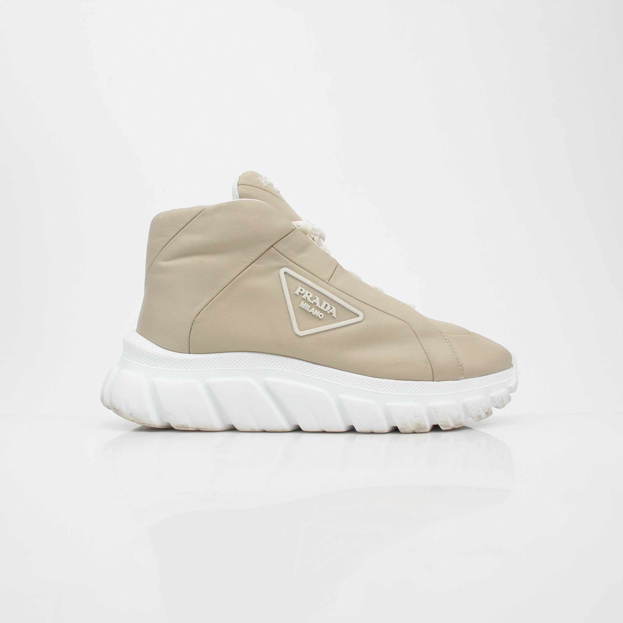 Gold & Beyond Prada beige Rush Piuma high-top sneakers with textured detailing and white rubber soles.