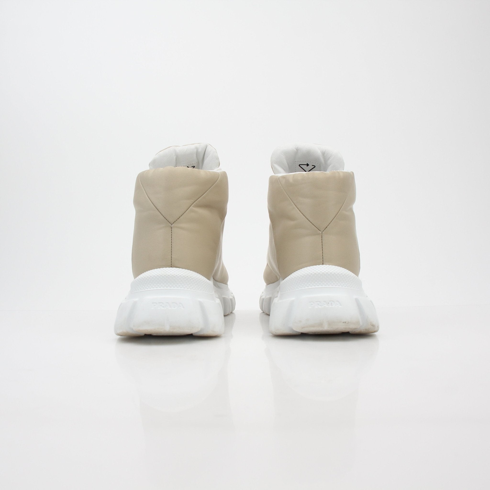Prada beige Rush Piuma high-top sneakers with gold accents, showcasing the stylish leather shoes from Gold & Beyond.