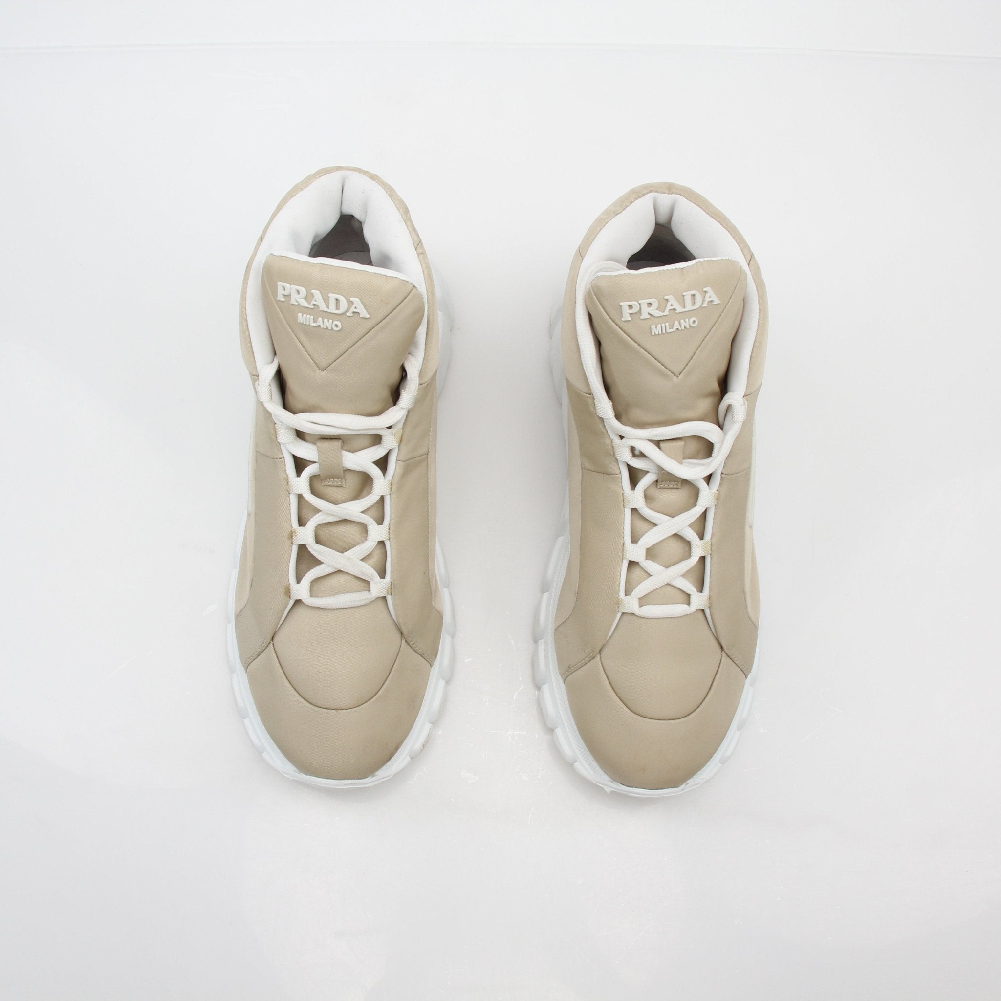 Gold & Beyond Prada Beige Rush Piuma high-top sneakers, stylish shoes with beige textured material and lace-up design.