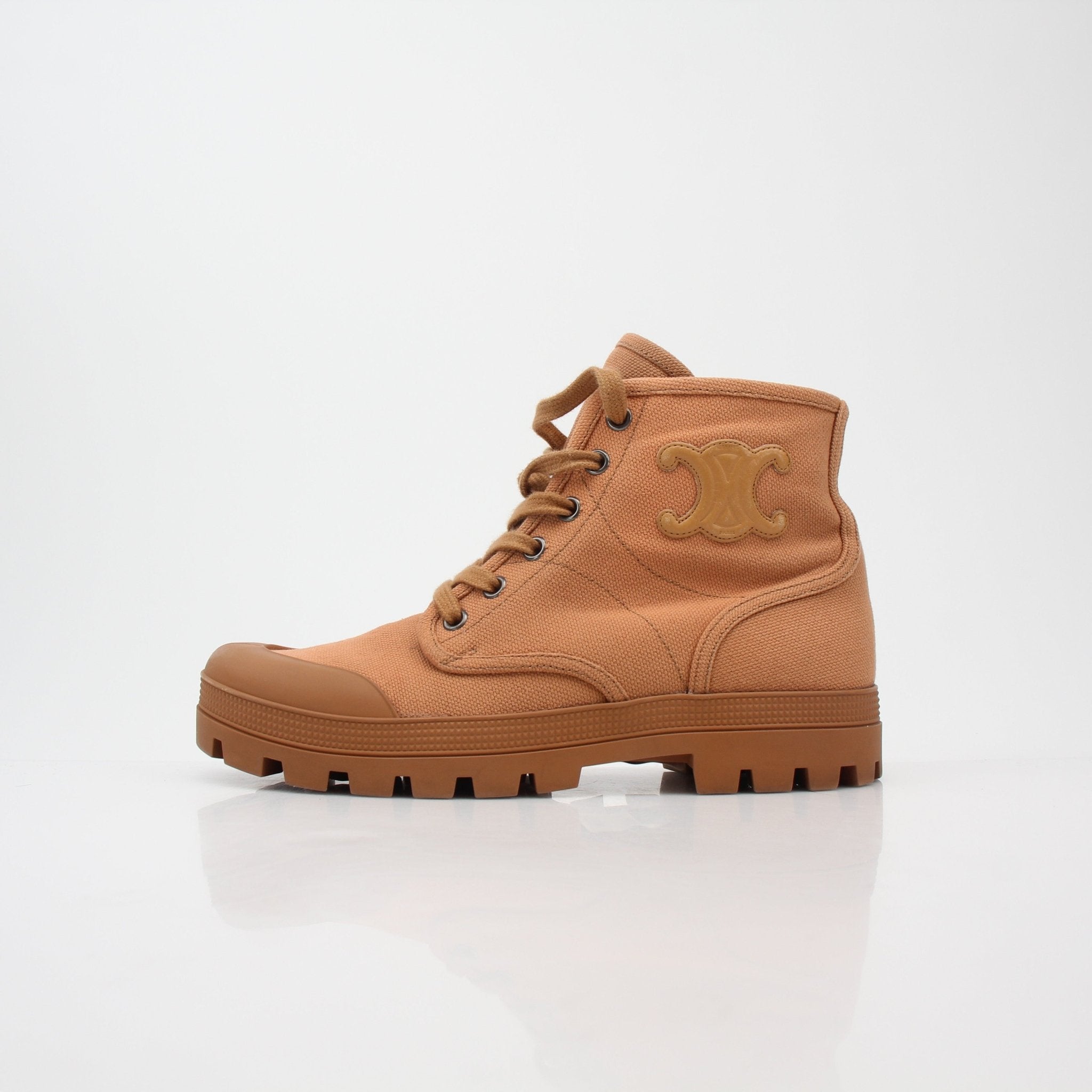 Gold & Beyond Celine Tan Patapans lace-up boots with stylish leather finish and sturdy sole, perfect for casual or dressy outfits.