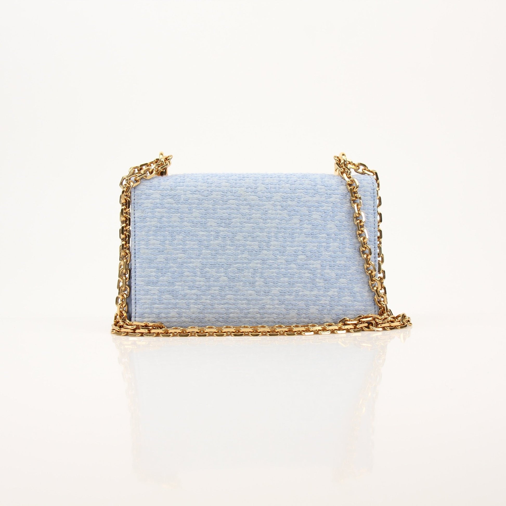 Light blue Dolce Gabbana DG Girl shoulder handbag in tweed fabric, showcasing its stylish design and elegant craftsmanship.