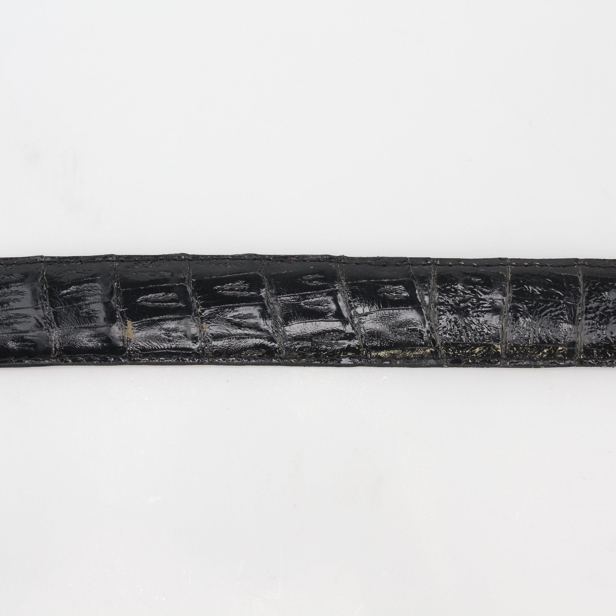 Black Christian Dior genuine alligator belt with gold-tone buckle, classic accessory for sophisticated style.