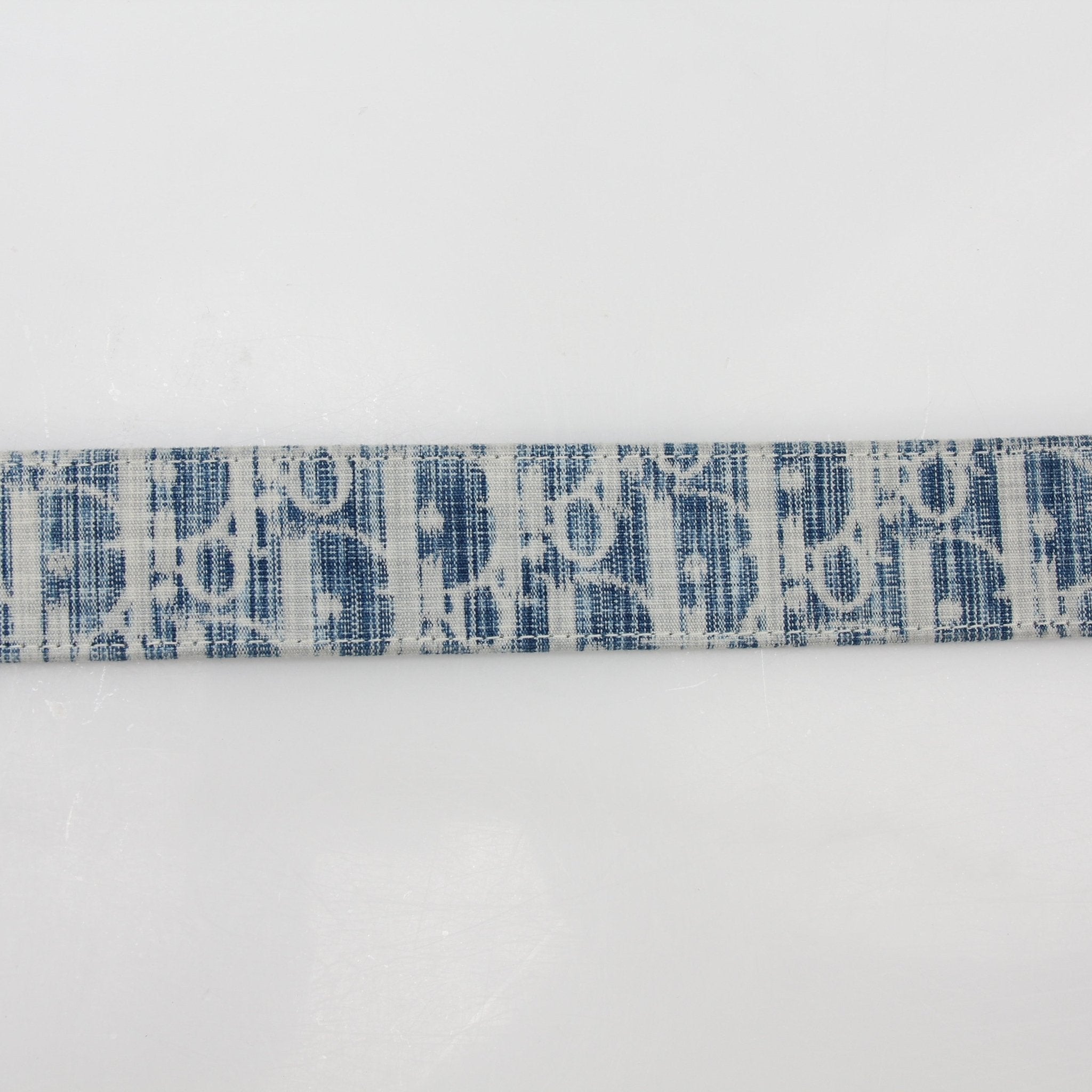 Christian Dior Blue Oblique denim reversible belt strap with gold accents, designed for accessories and adjustable fit.