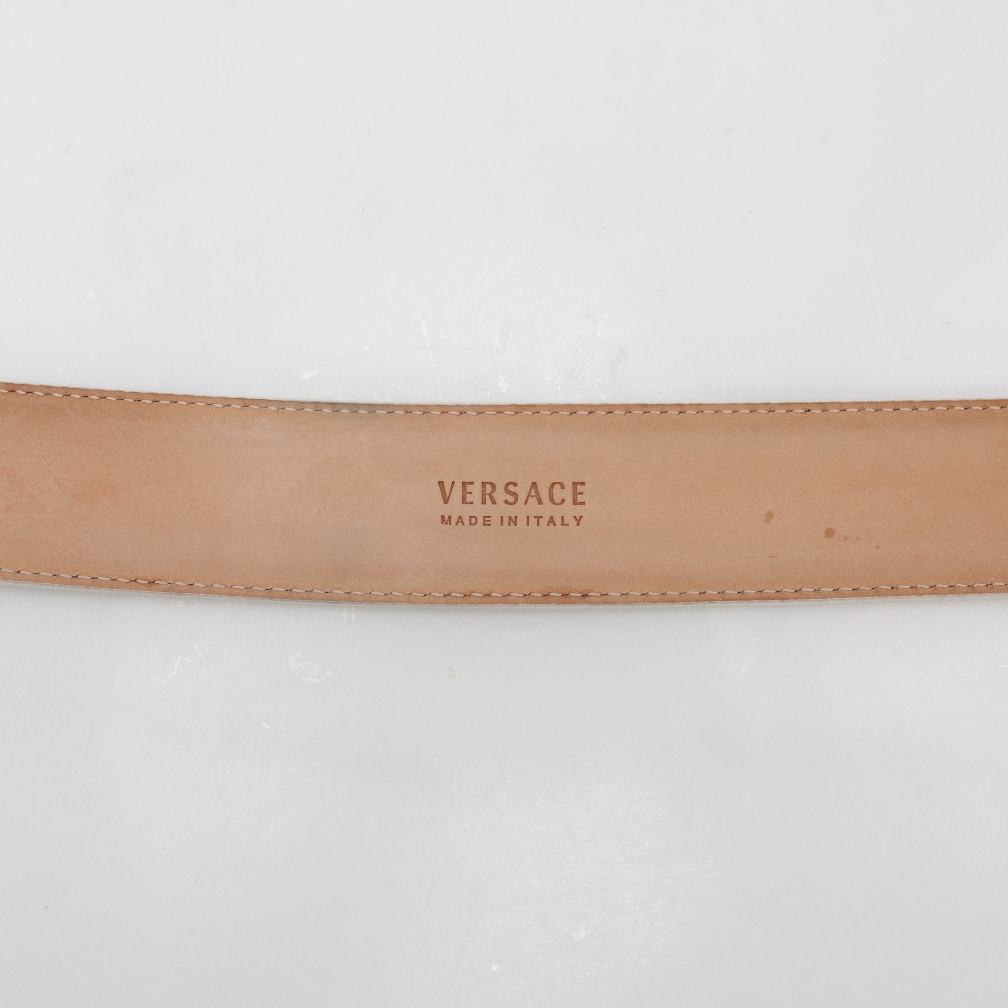 White leather Versace La Medusa belt with gold-tone buckle, stylish accessory for men and women.