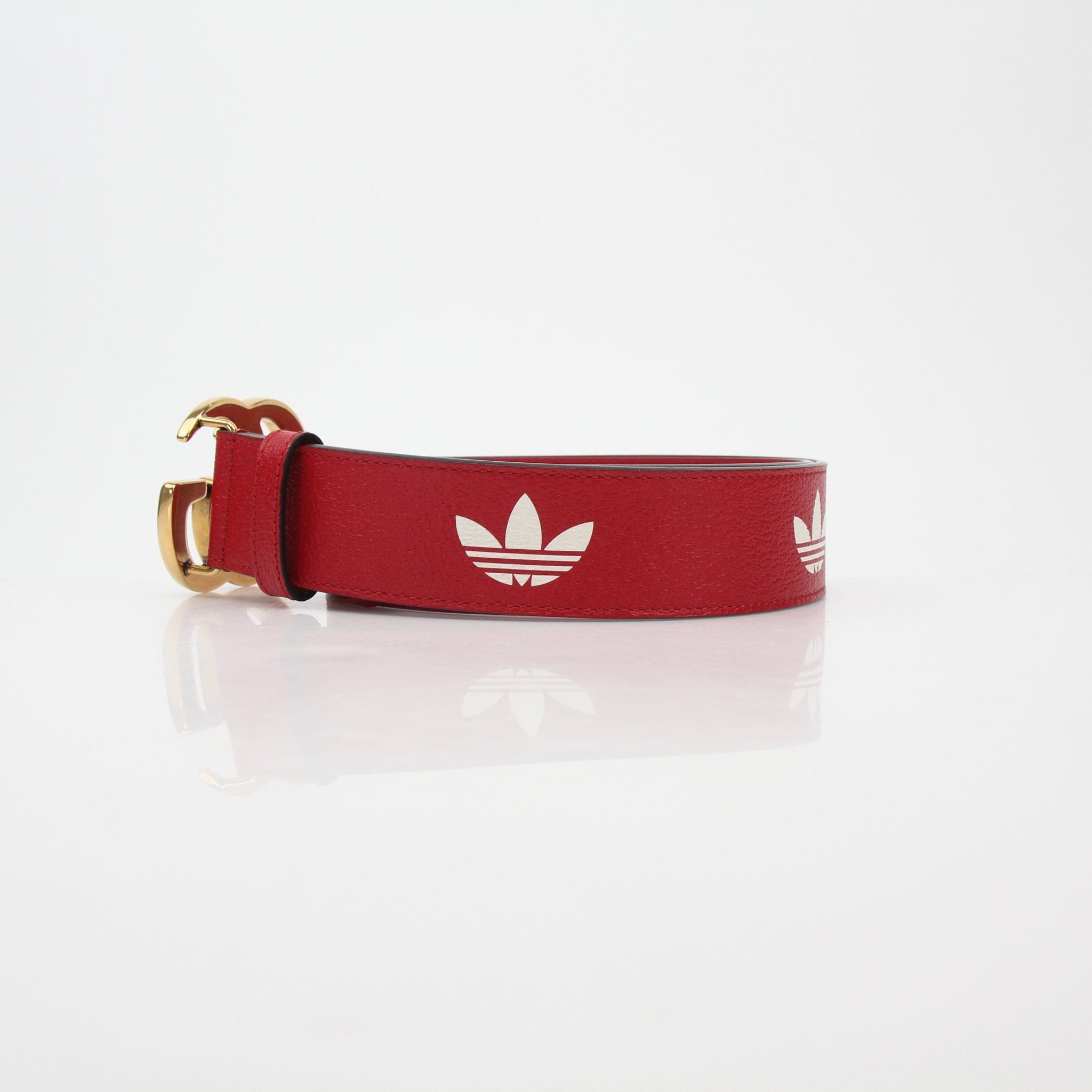 Red leather GG Marmont belt by Adidas x Gucci, showcasing the iconic GG logo buckle on a stylish accessories belt.