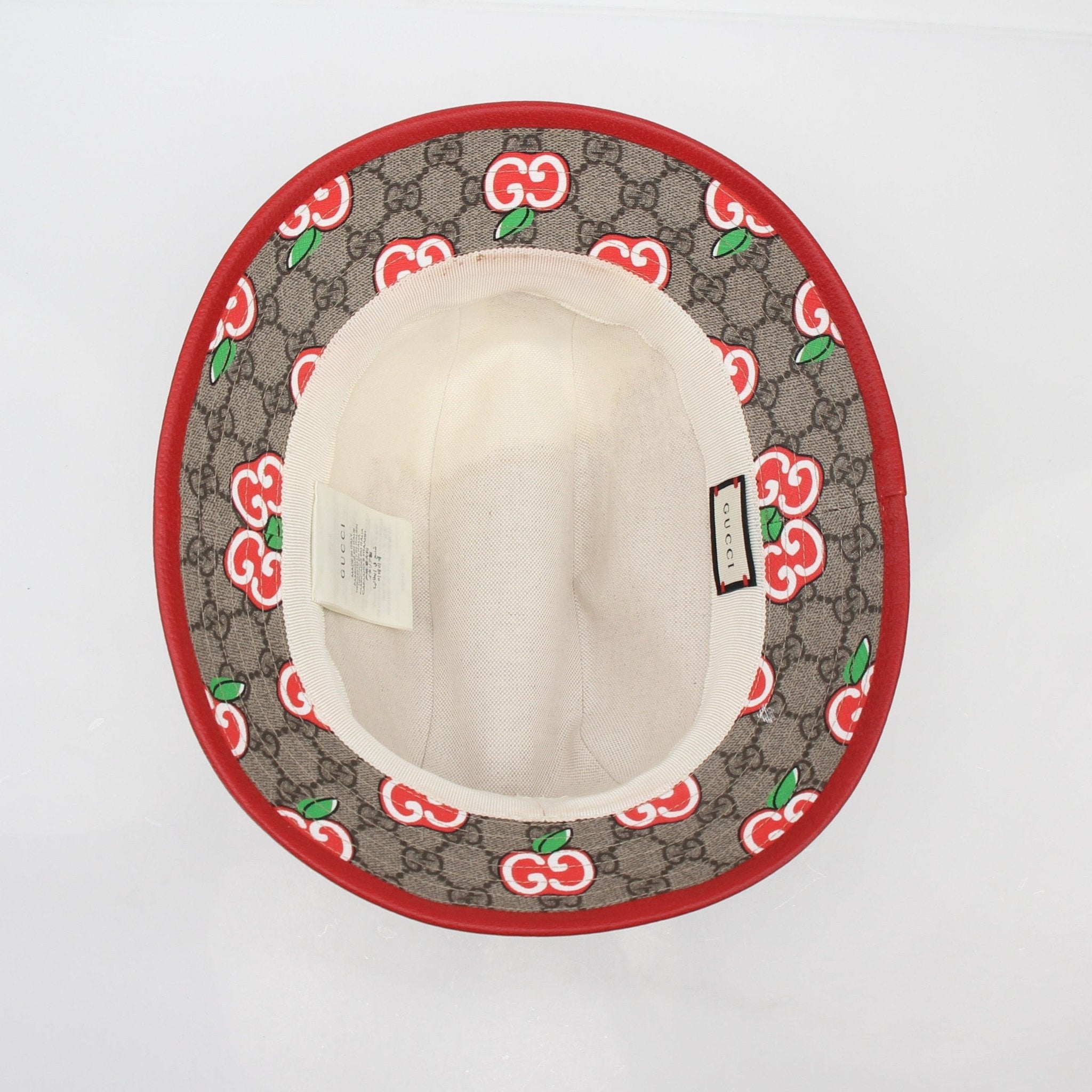 Gucci GG Supreme Apple print bucket hat, gold and beyond accessories, featuring the signature fabric and stylish design.