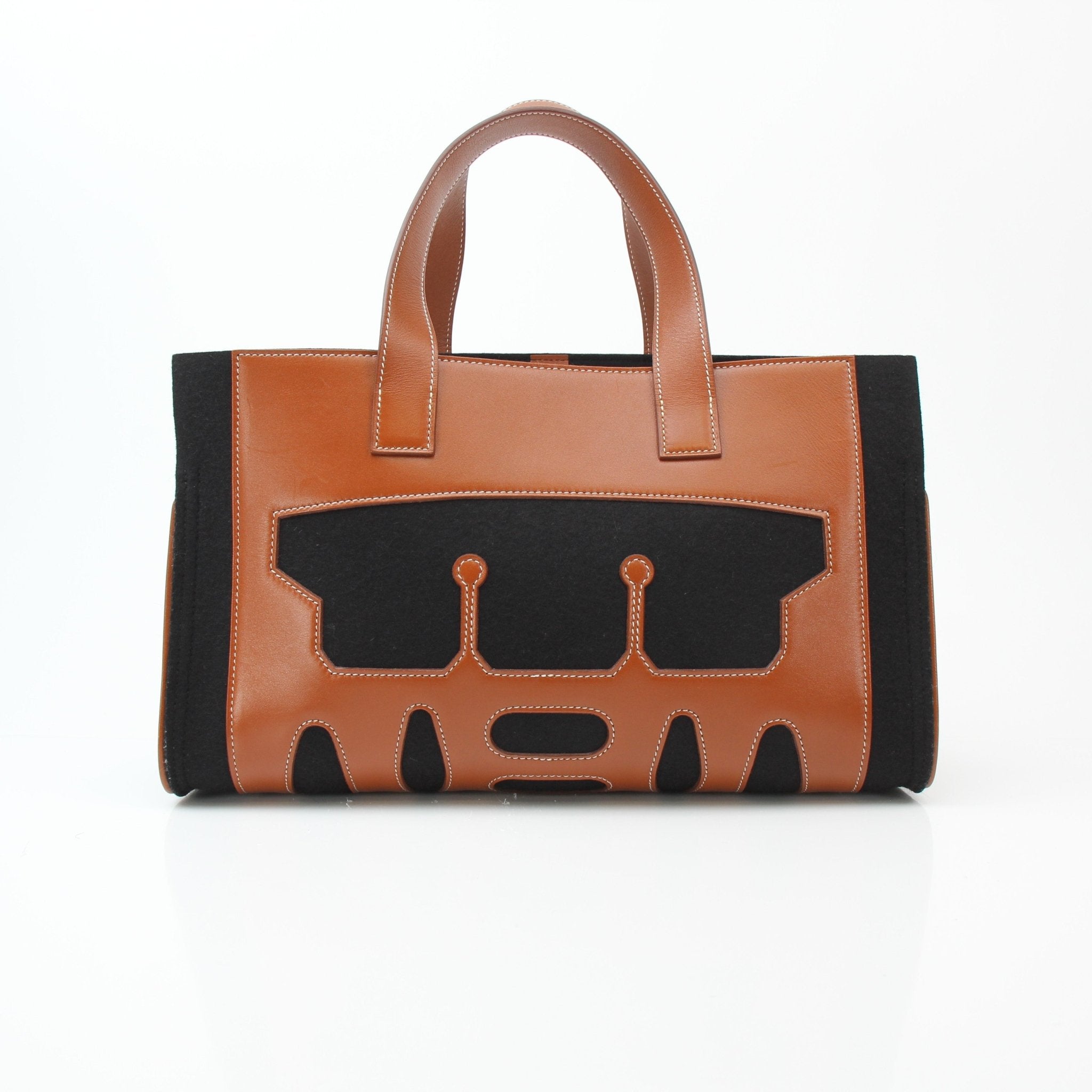 Hermès Petit H Skeleton Garden Tote handbag with leather handles and detailed design, displayed on a neutral background.
