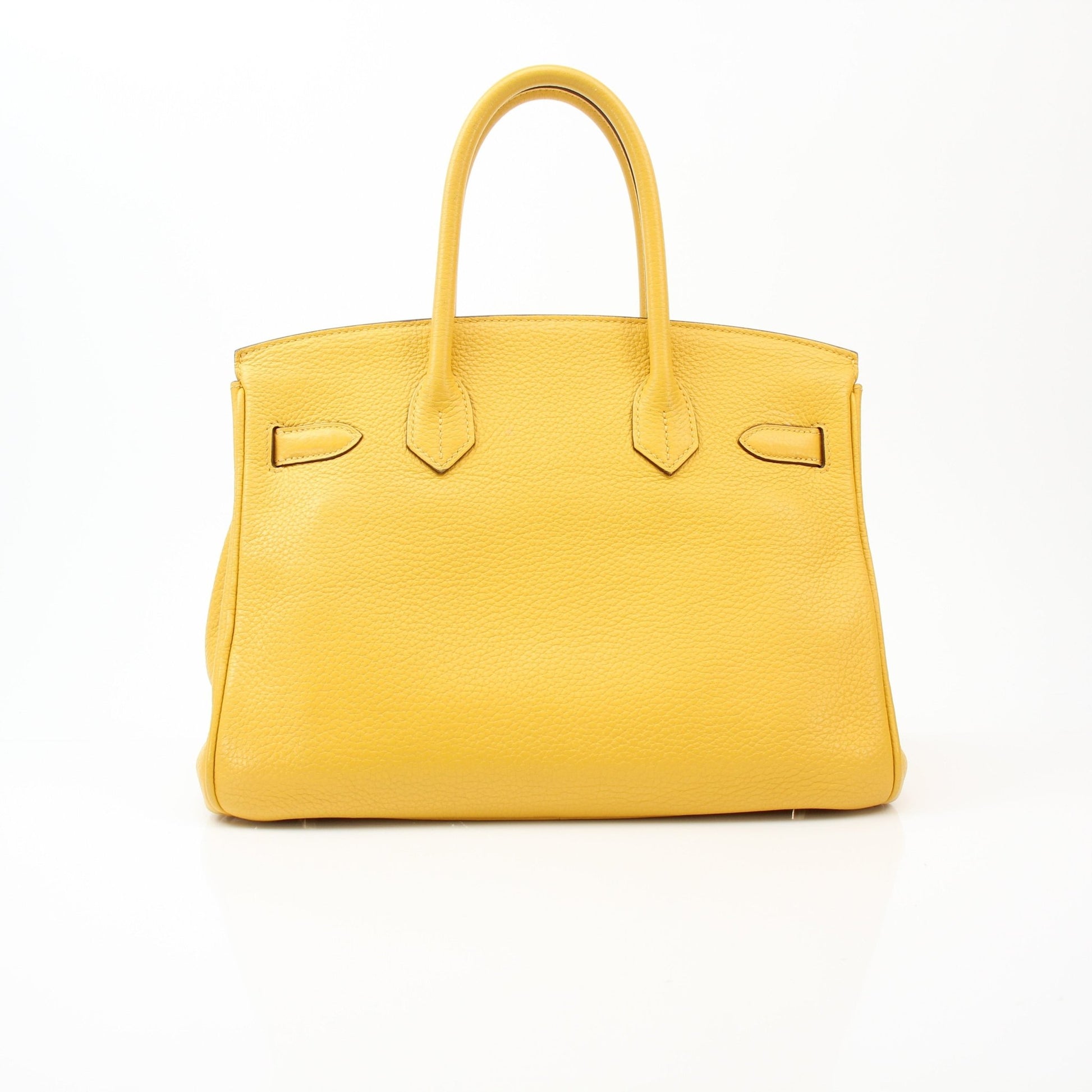 Yellow Hermès Birkin 30 handbag with gold hardware, crafted from luxurious leather, displayed on a neutral background.