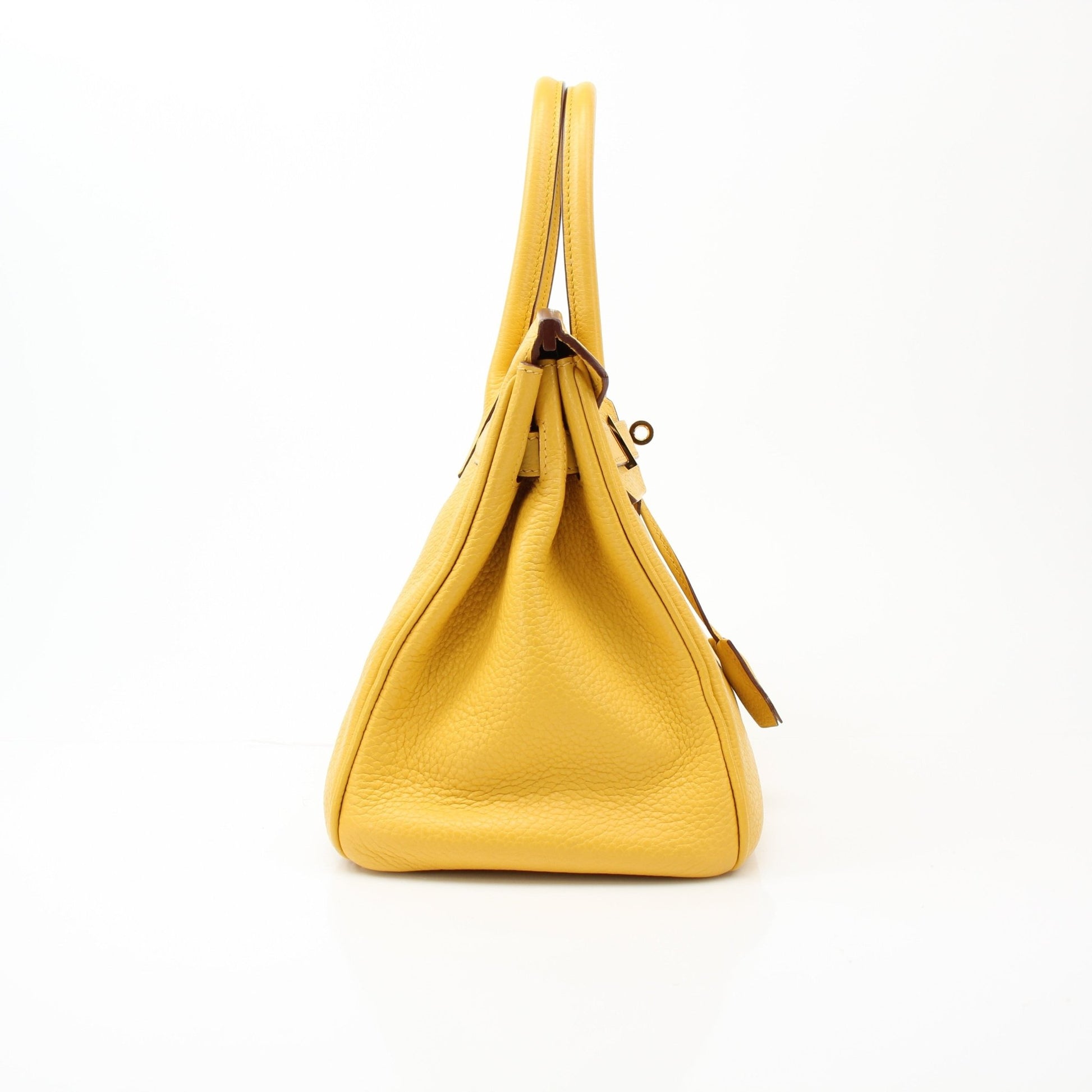 Yellow Hermès Birkin 30 handbag with gold hardware, featuring luxurious leather and classic design by Hermès.