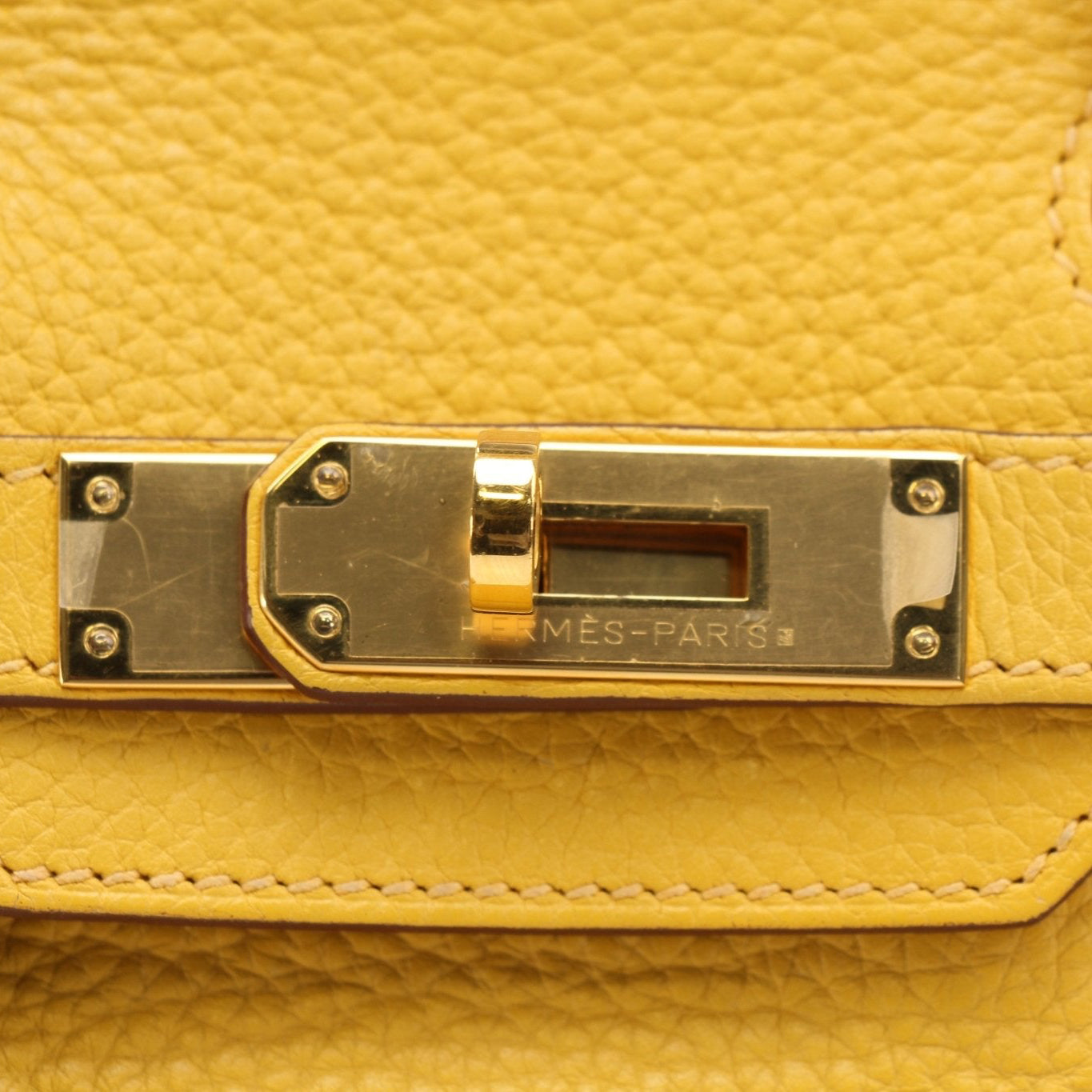 Hermès Birkin 30 yellow handbag with gold hardware, showcasing luxurious leather craftsmanship by Gold & Beyond.