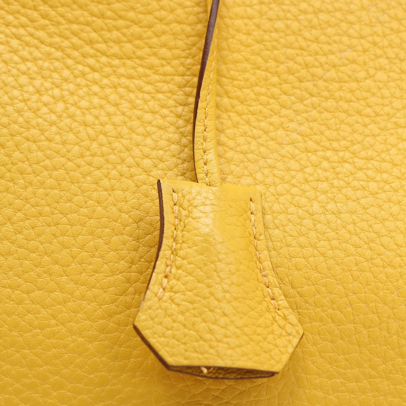 Hermès Birkin 30 yellow handbag with gold hardware, displayed on a neutral background.