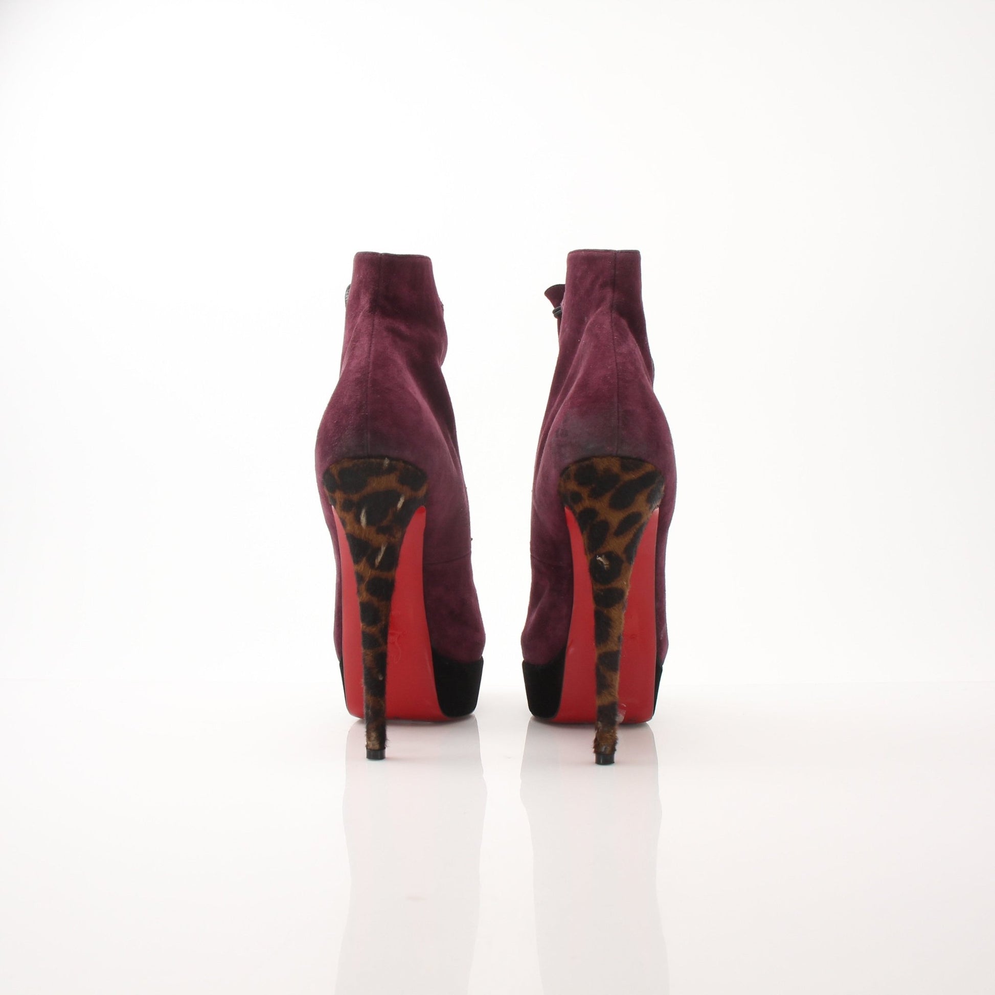 Christian Louboutin women's Lady Booton 140 ankle boots in black leather with red soles, stylish and elegant shoe design.