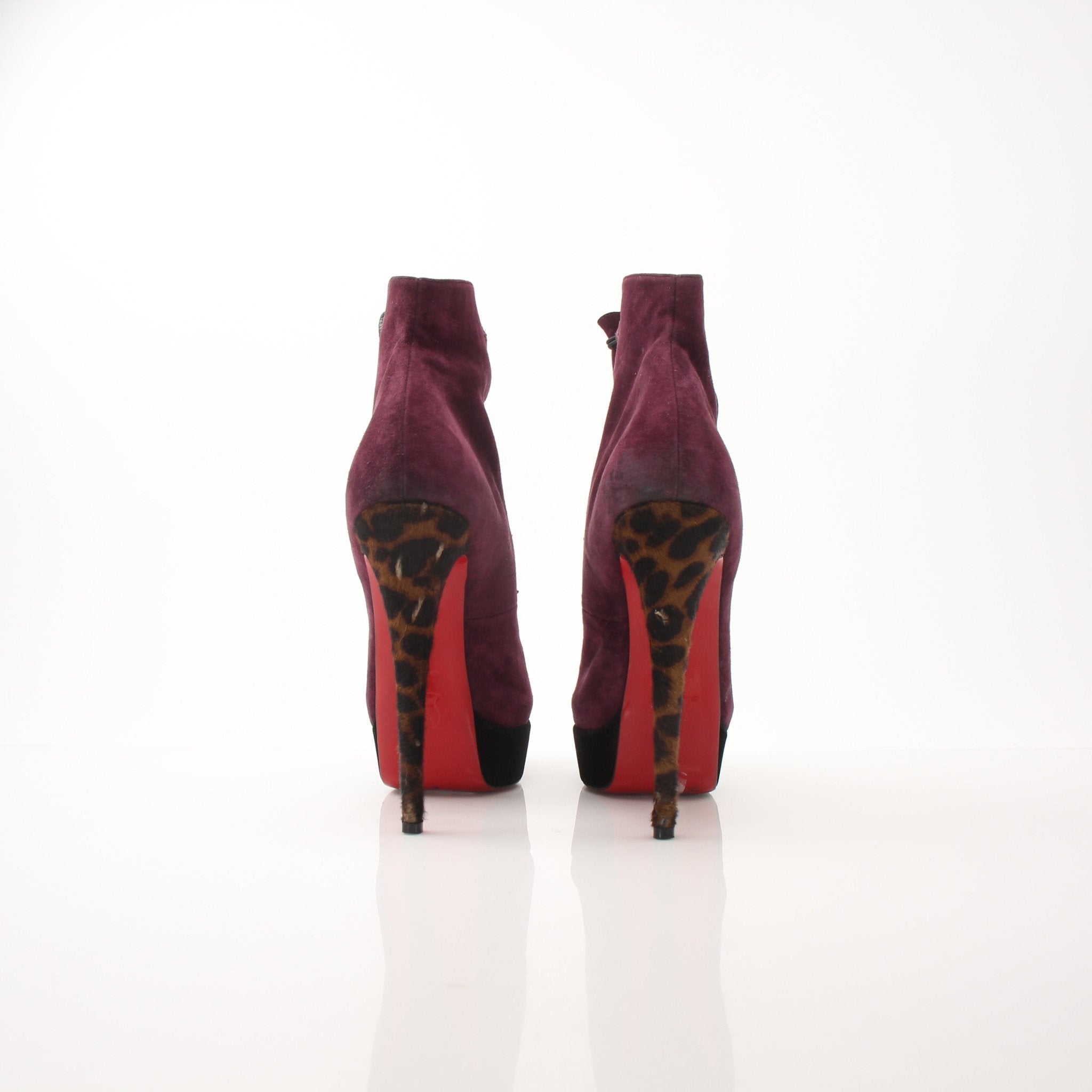 Christian Louboutin women's Lady Booton 140 ankle boots in black leather with red soles, stylish and elegant shoe design.