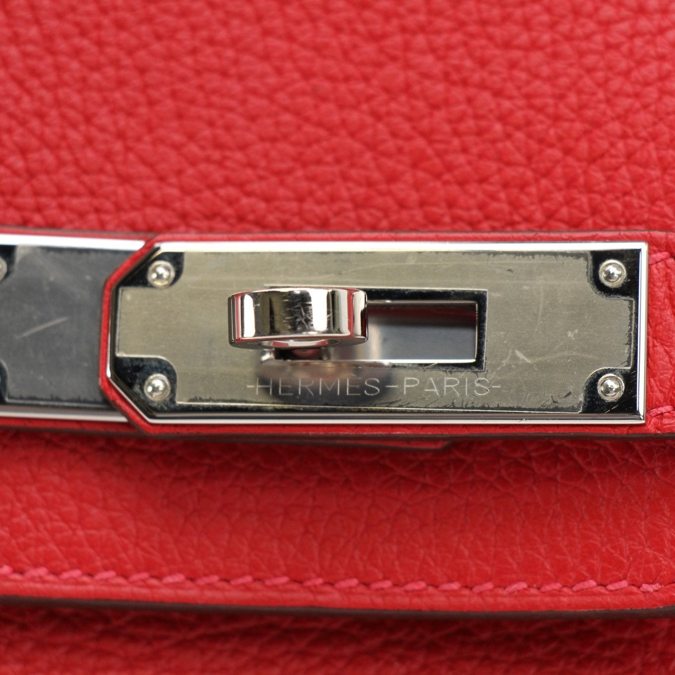 Hermès Birkin 30 Geranium handbag with gold hardware, featuring leather texture and elegant design.