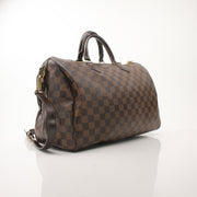 Gold & Beyond Louis Vuitton Speedy Bandouliere 35 shoes with stylish design and classic branding, displayed on a neutral background.