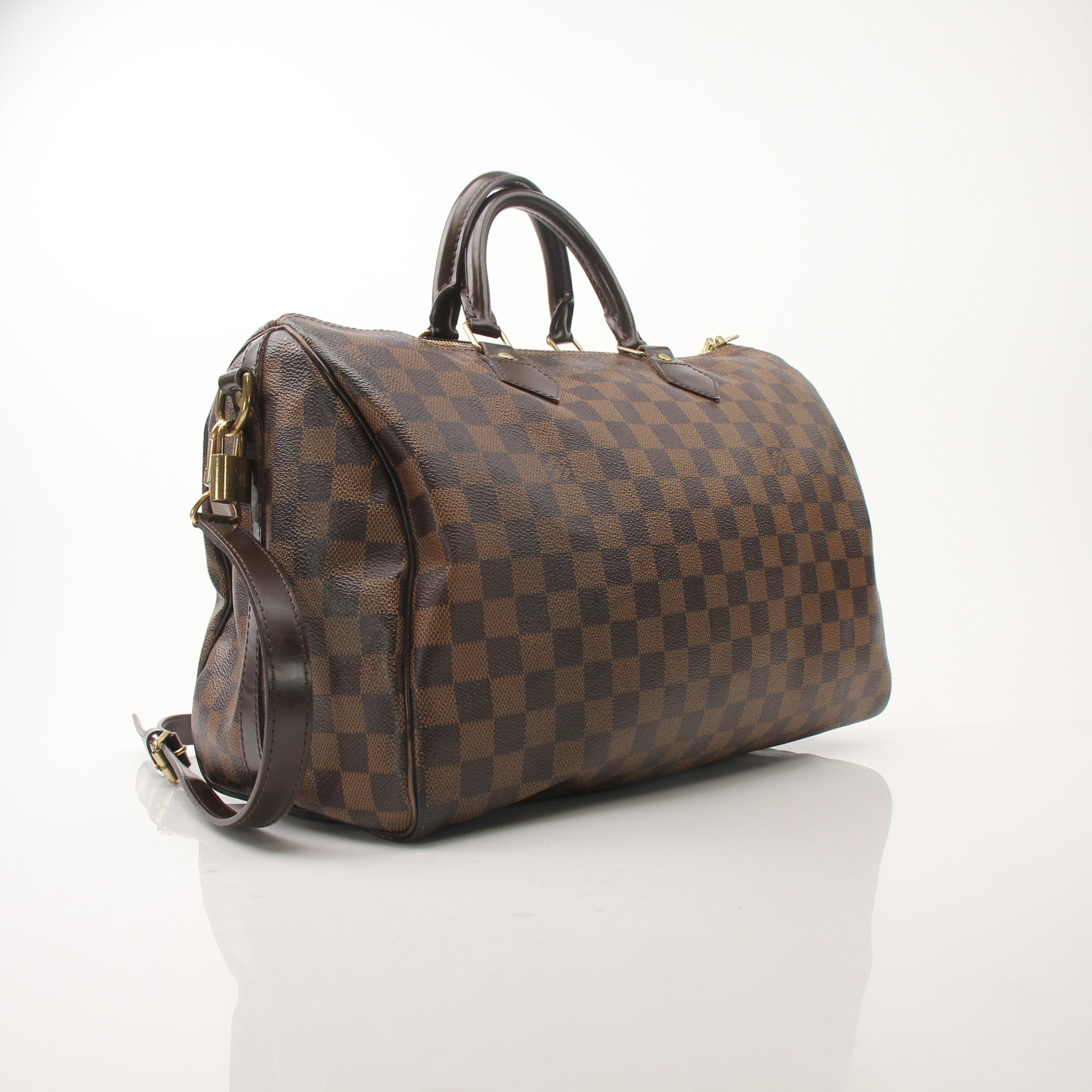 Gold & Beyond Louis Vuitton Speedy Bandouliere 35 shoes with stylish design and classic branding, displayed on a neutral background.
