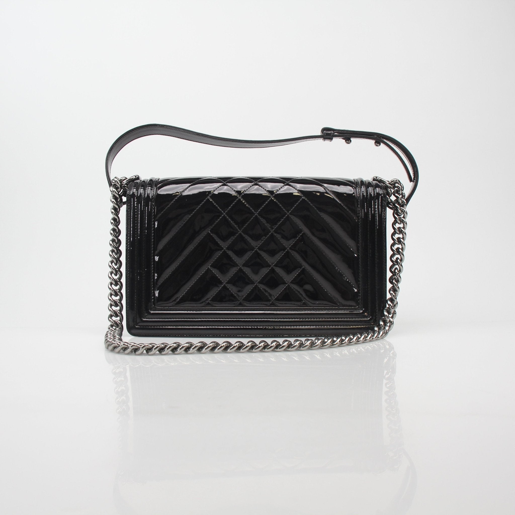 Gold & Beyond Chanel black patent quilted Boy Flap handbag with gold hardware and signature quilting detail.