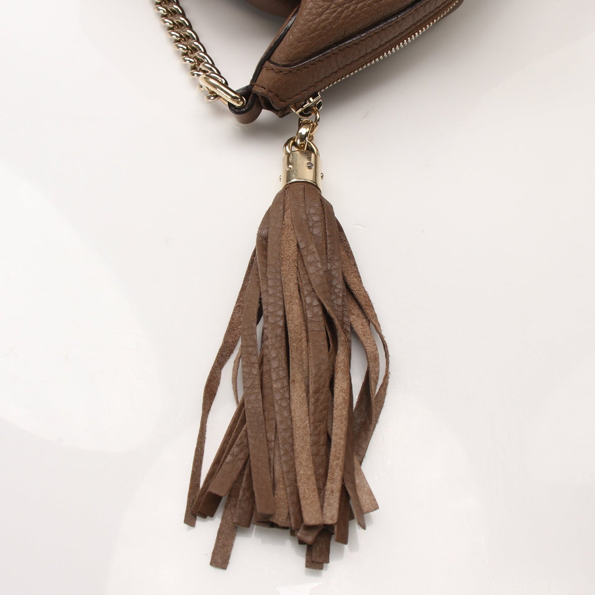 Gucci Soho Chain Shoulder Bag with gold chain strap and black leather body, stylish handbag by Gold & Beyond