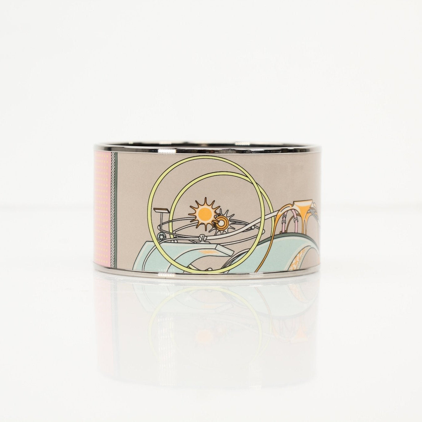 Hermès enamel cuff bracelet featuring colorful enamel inlay and sleek gold-tone jewelry design by Gold & Beyond.