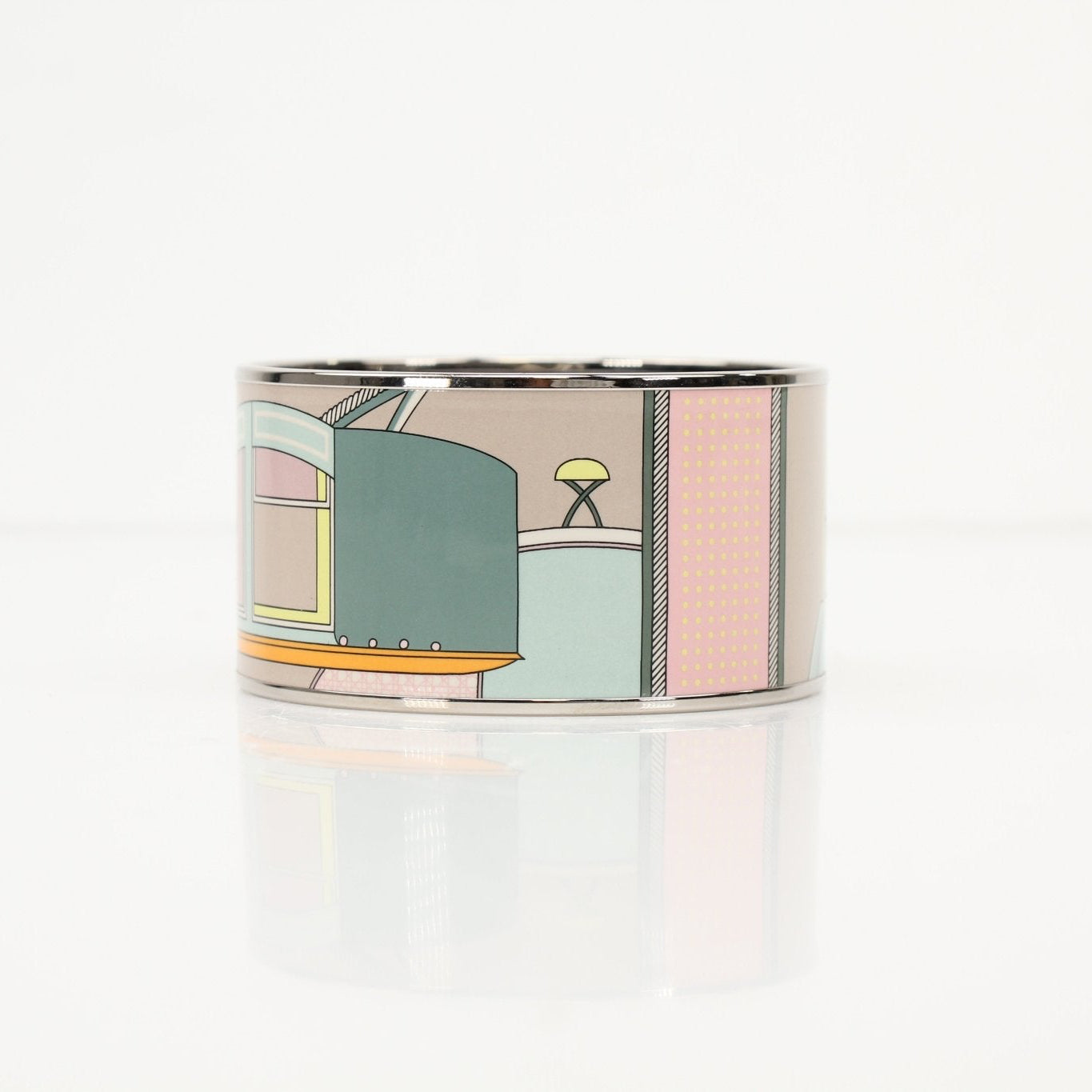 Hermès enamel cuff bracelet featuring colorful enamel design and gold-tone jewelry details.