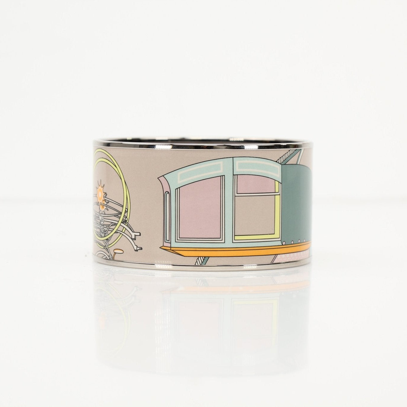 Hermès enamel cuff bracelet in jewelry, featuring colorful enamel design and gold accents, displayed on a neutral background.