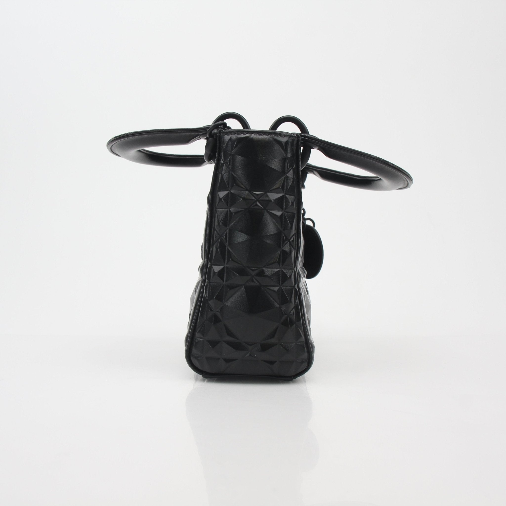 Black Christian Dior Lady Dior mini tote bag with gold hardware, featuring signature quilting and top handles.