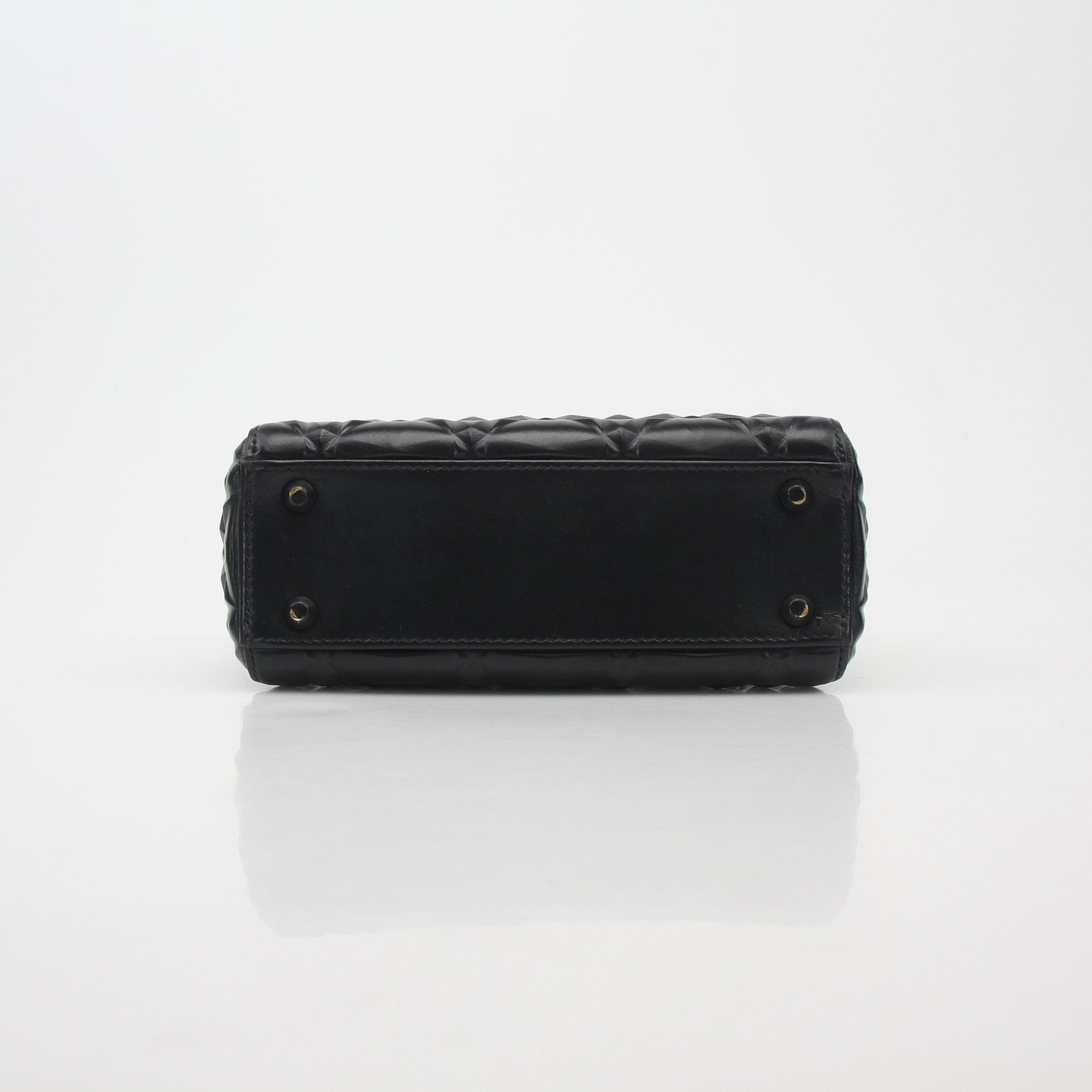Black Christian Dior Lady Dior mini tote handbag with gold accents, featuring signature quilting and top handles.