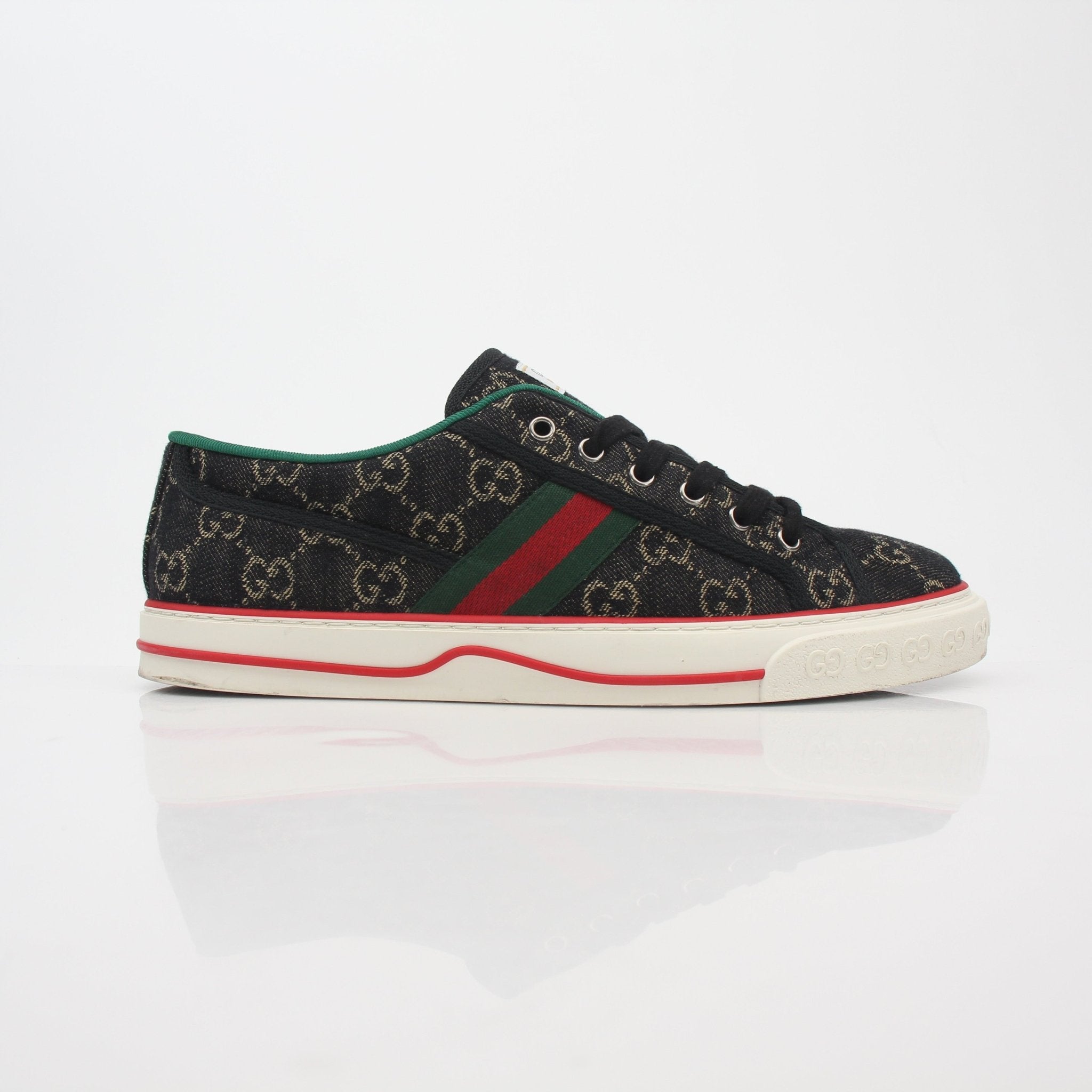 Gucci Black GG Denim Tennis 1977 Low-Top Sneakers with white rubber soles and gold accents, displayed on a plain background.
