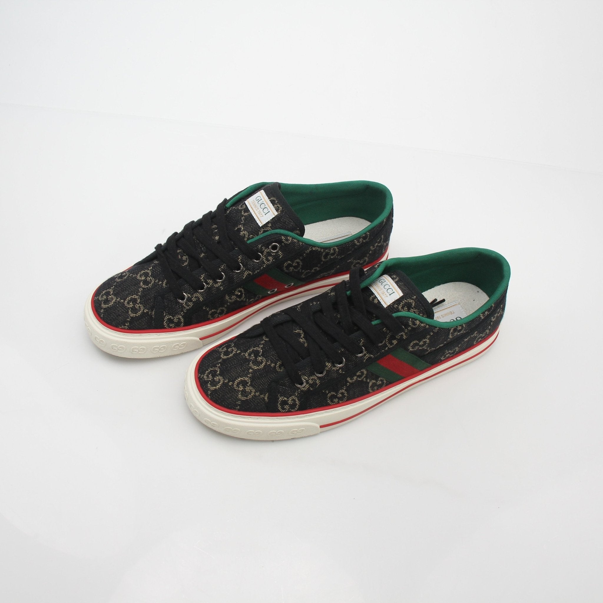 Gold & Beyond Gucci Black GG Denim Tennis 1977 low-top sneakers with white rubber soles and classic branding details.