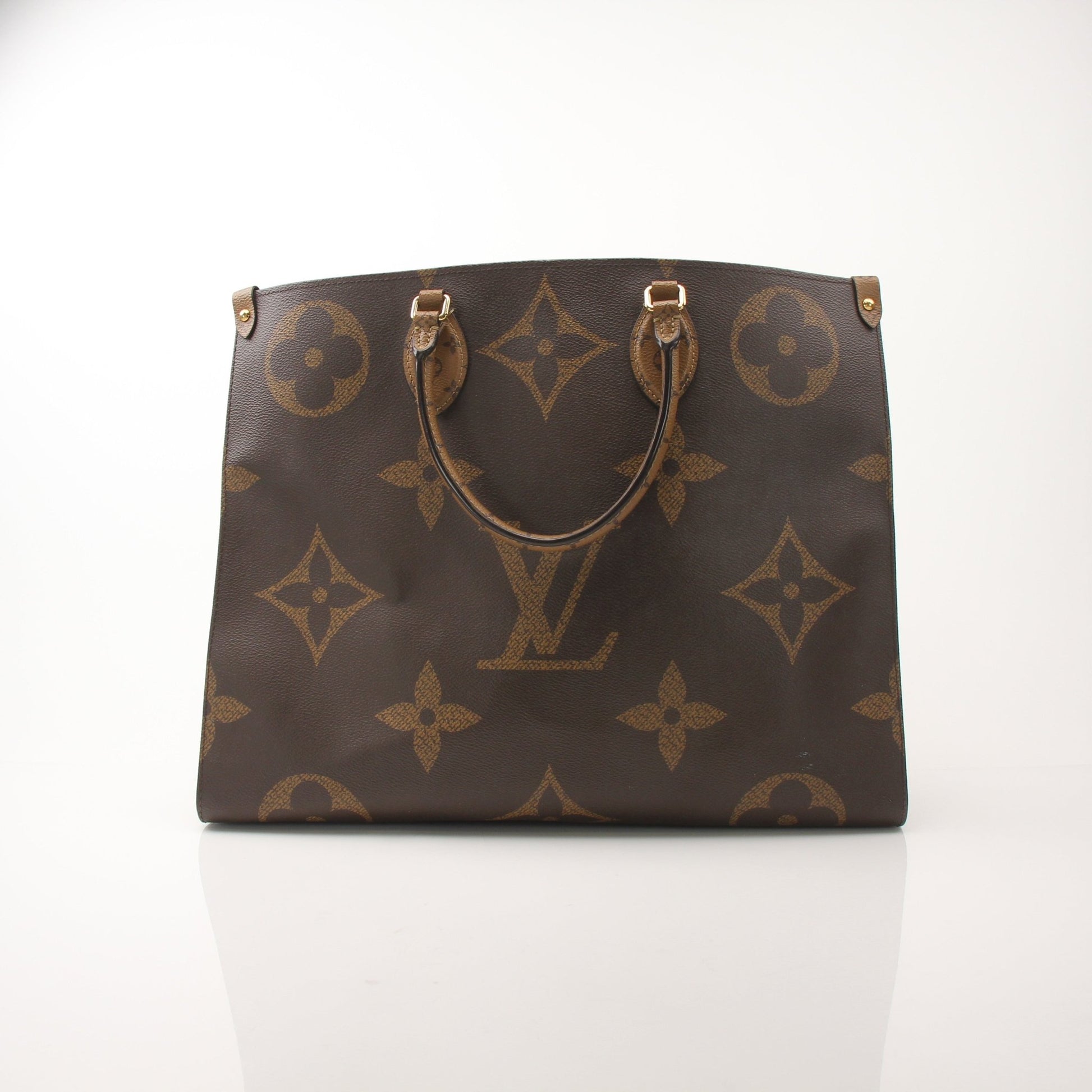 Louis Vuitton OnTheGo Reverse MM handbag in monogram canvas with gold-tone hardware and leather handles.